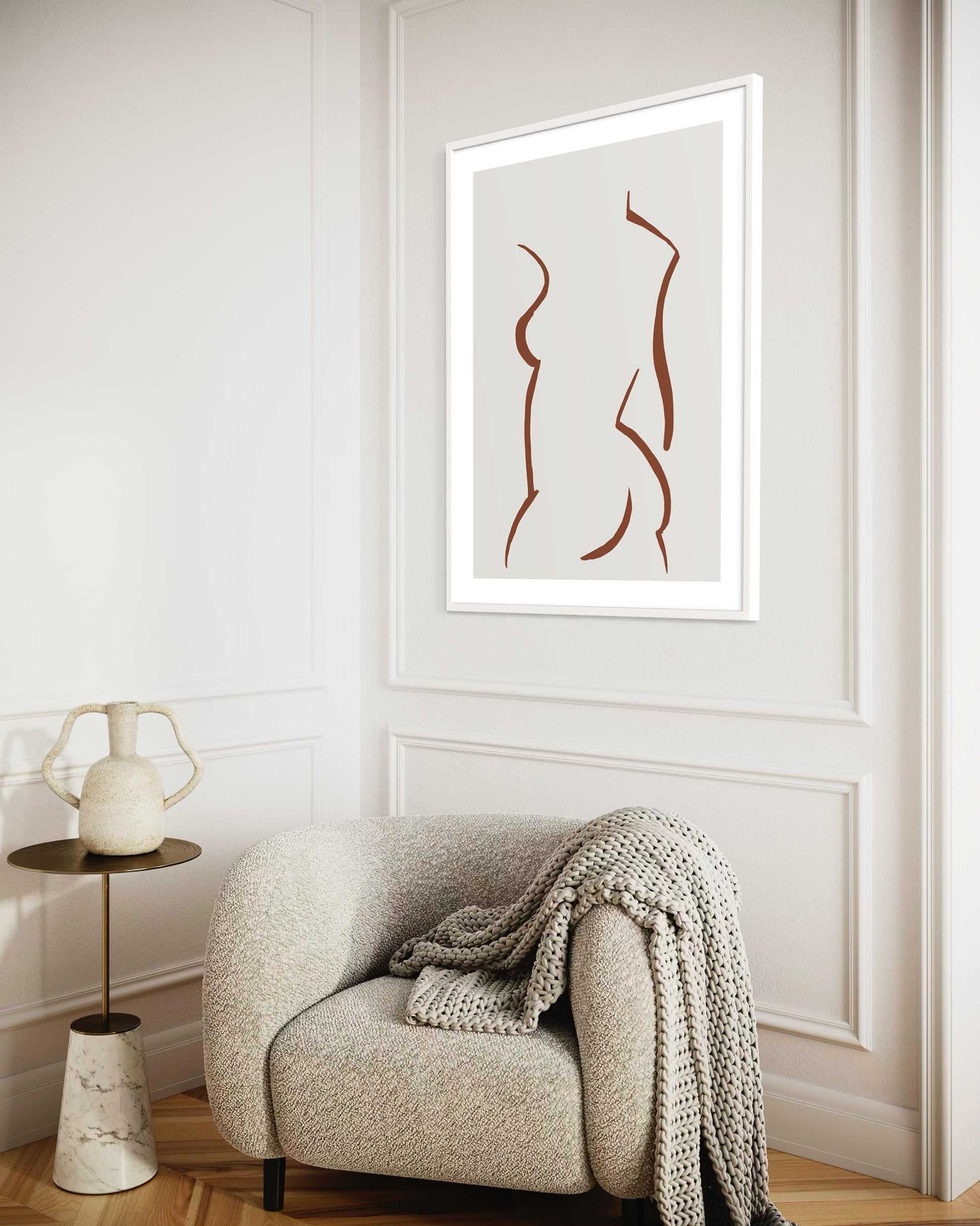 Modern interior with a chair, side table, and abstract art on the wall.