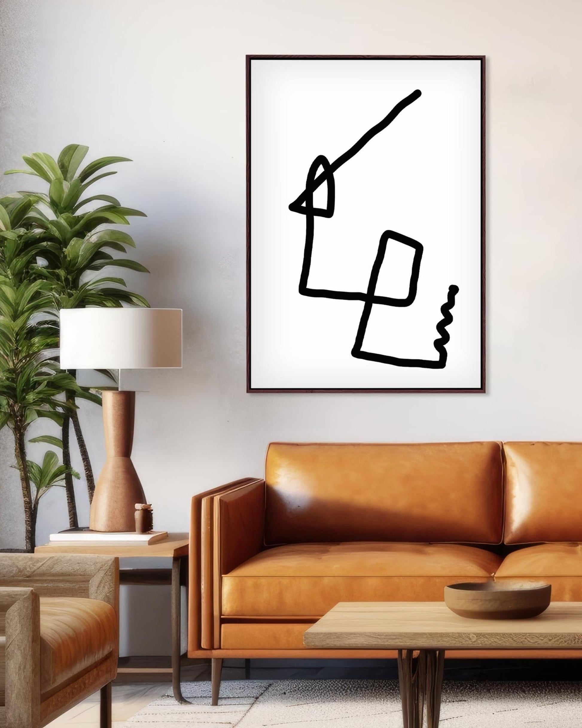 Modern living room with a brown leather sofa, armchair, and abstract art on the wall.