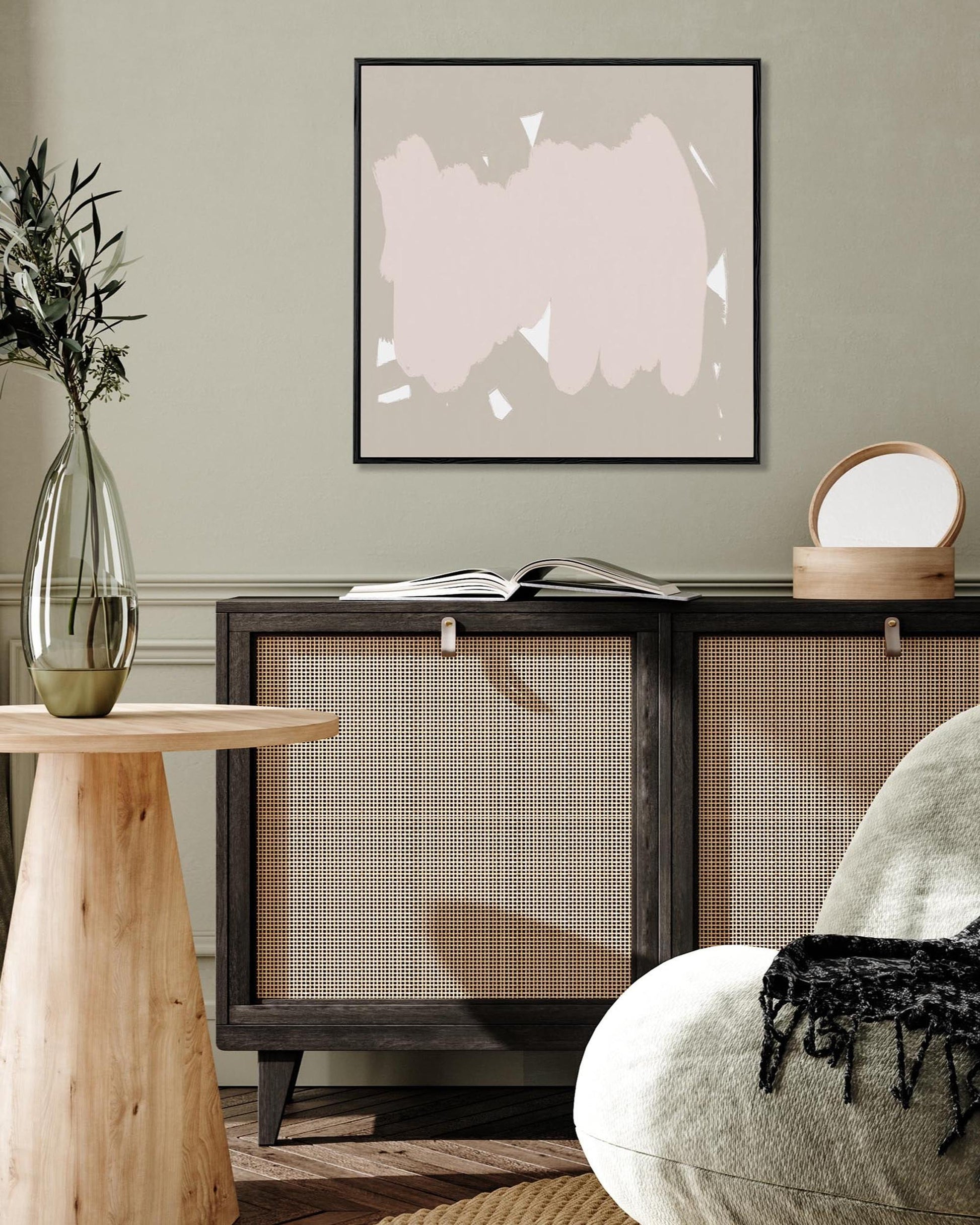 Modern interior with abstract art, wooden side table, and armchair.