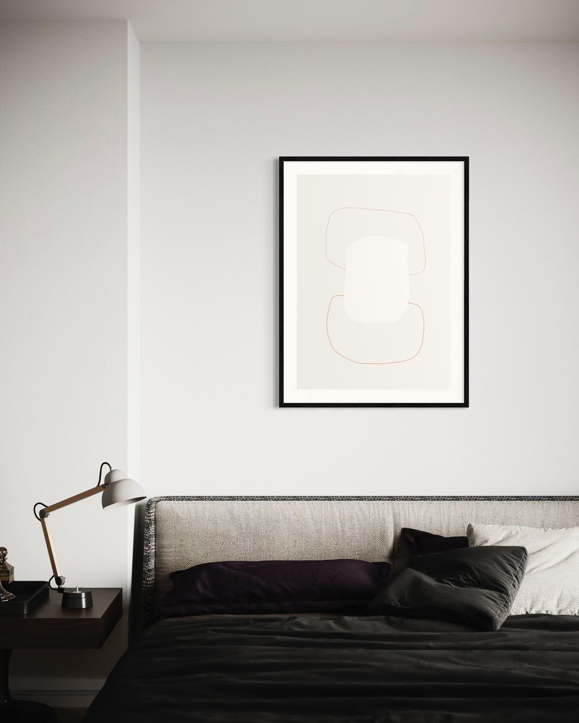 Framed abstract art above a bed in a bedroom setting