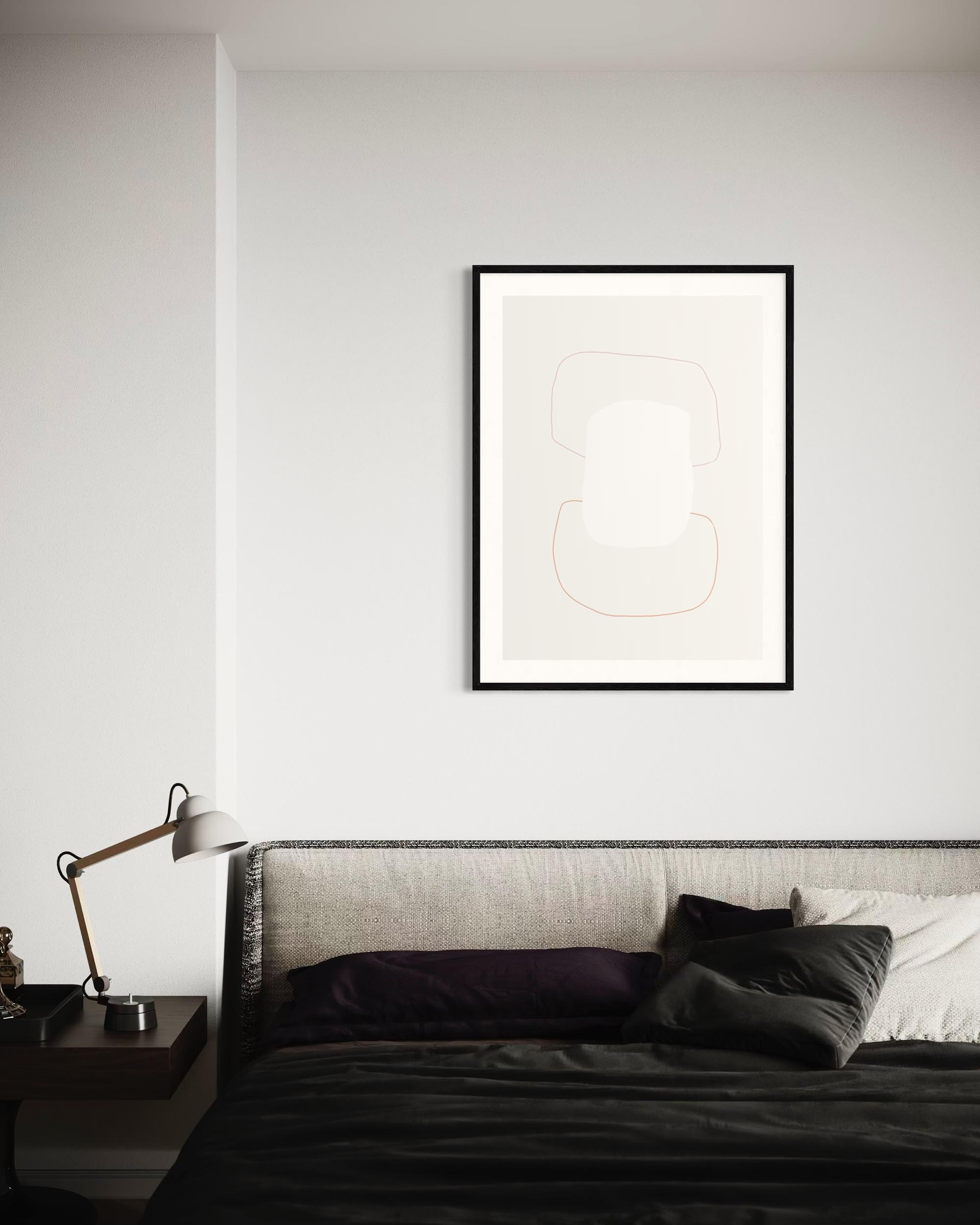 Framed abstract art above a bed in a bedroom setting