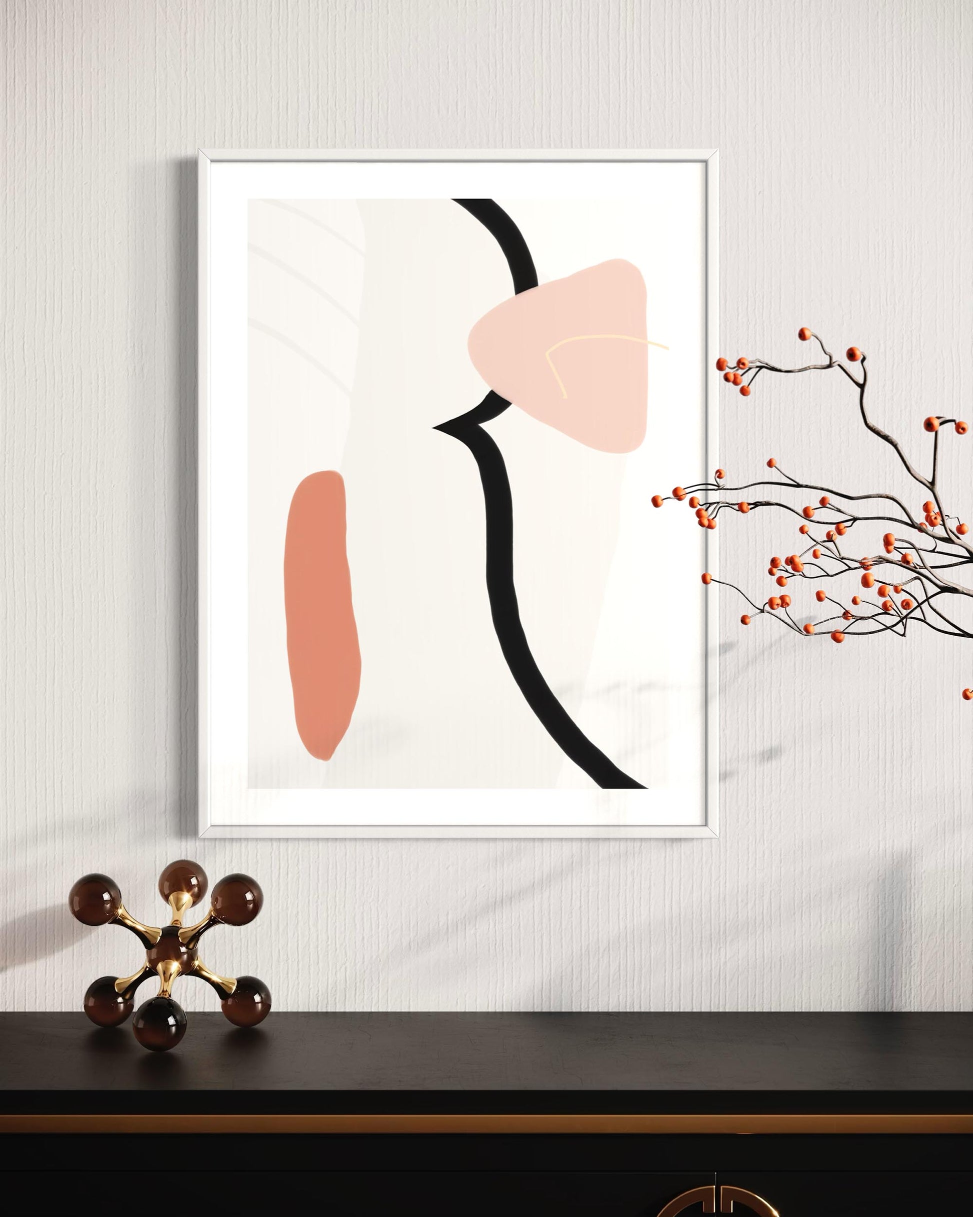 Framed abstract art print with geometric shapes on a wall above a desk.