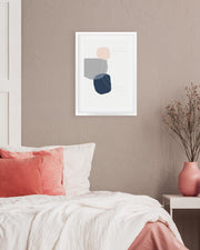 Abstract art print on a wall above a bed with pink and white bedding.
