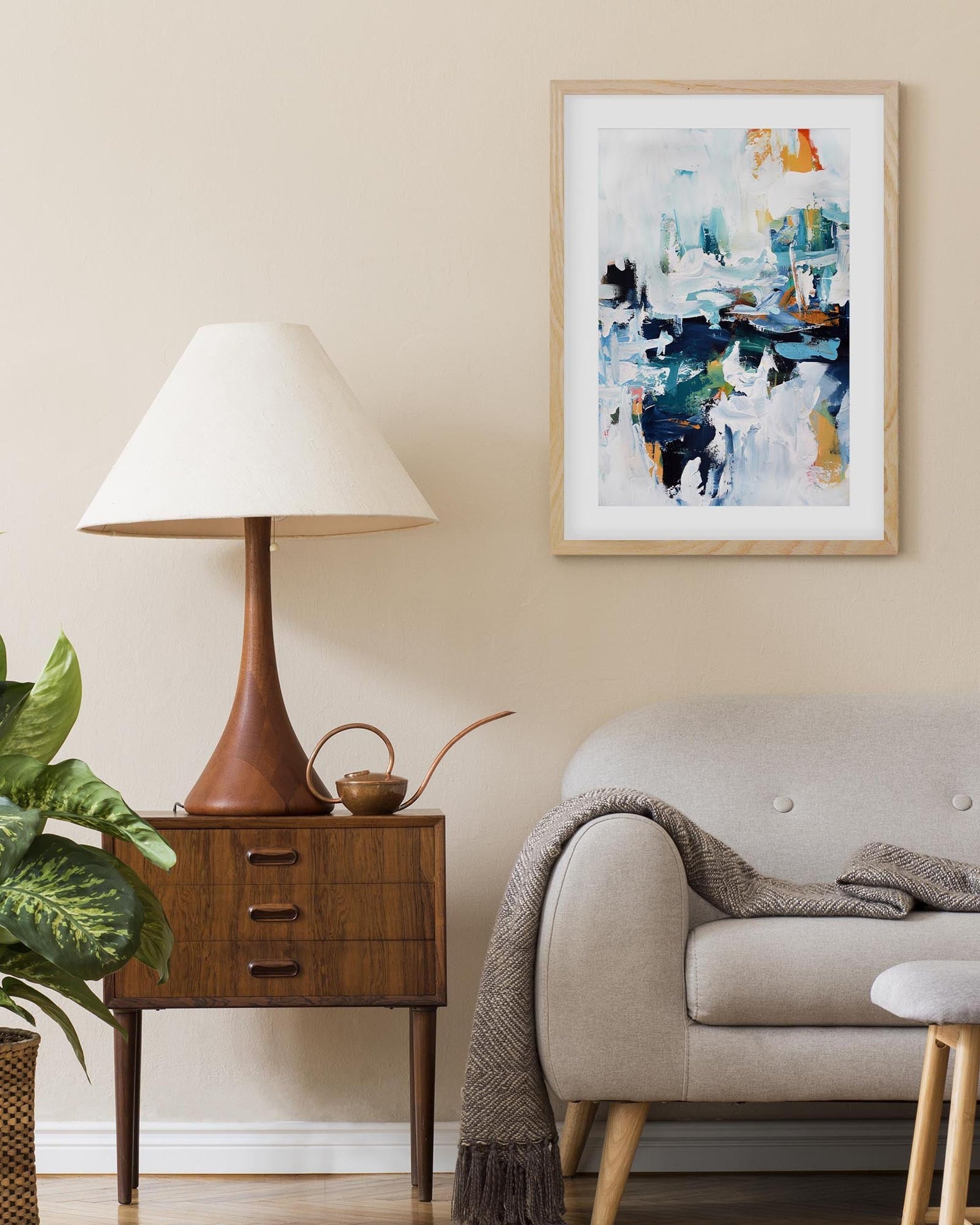 framed abstract wall art print on a wall above a sofa in living room