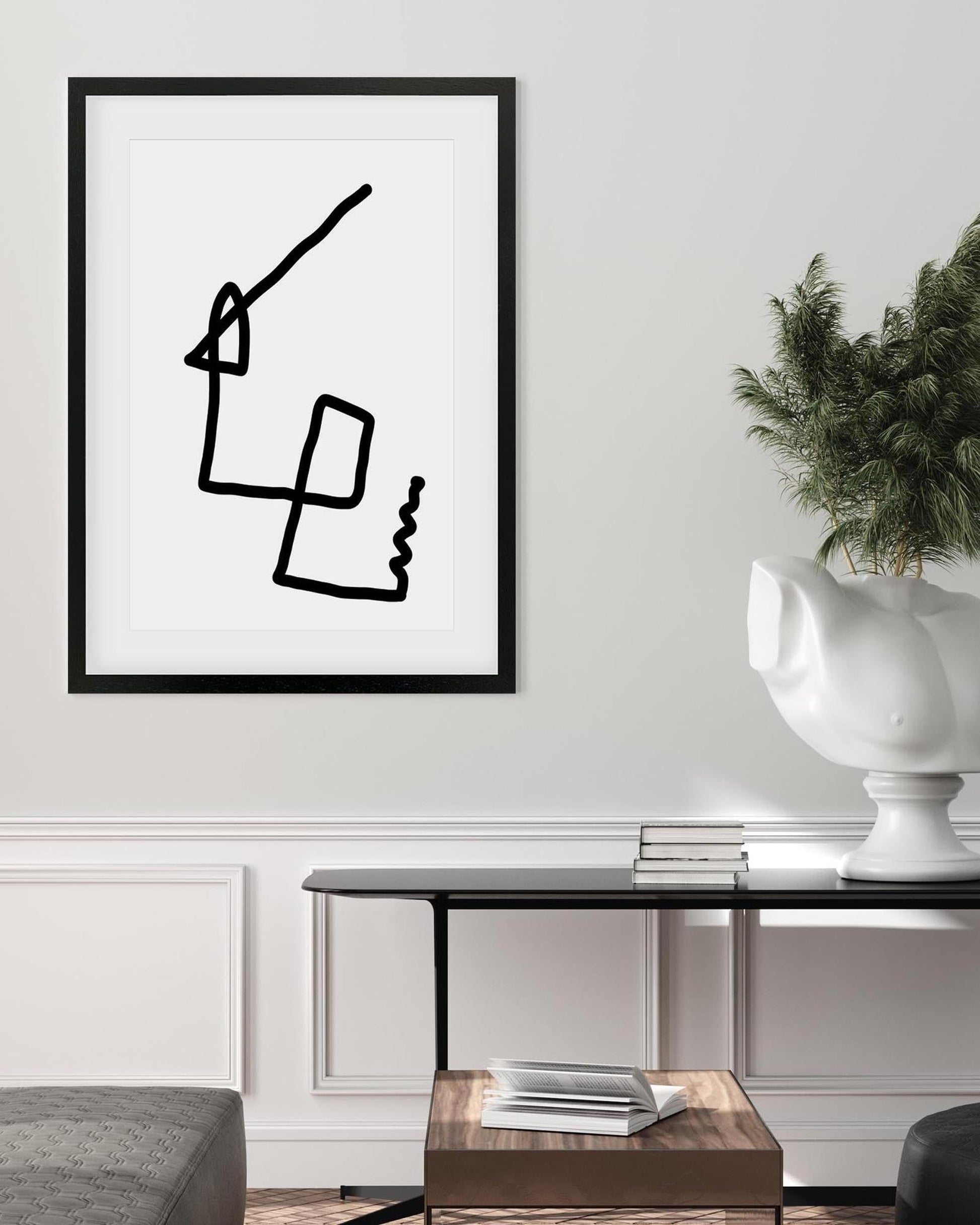 Framed abstract artwork on a wall in a living room setting