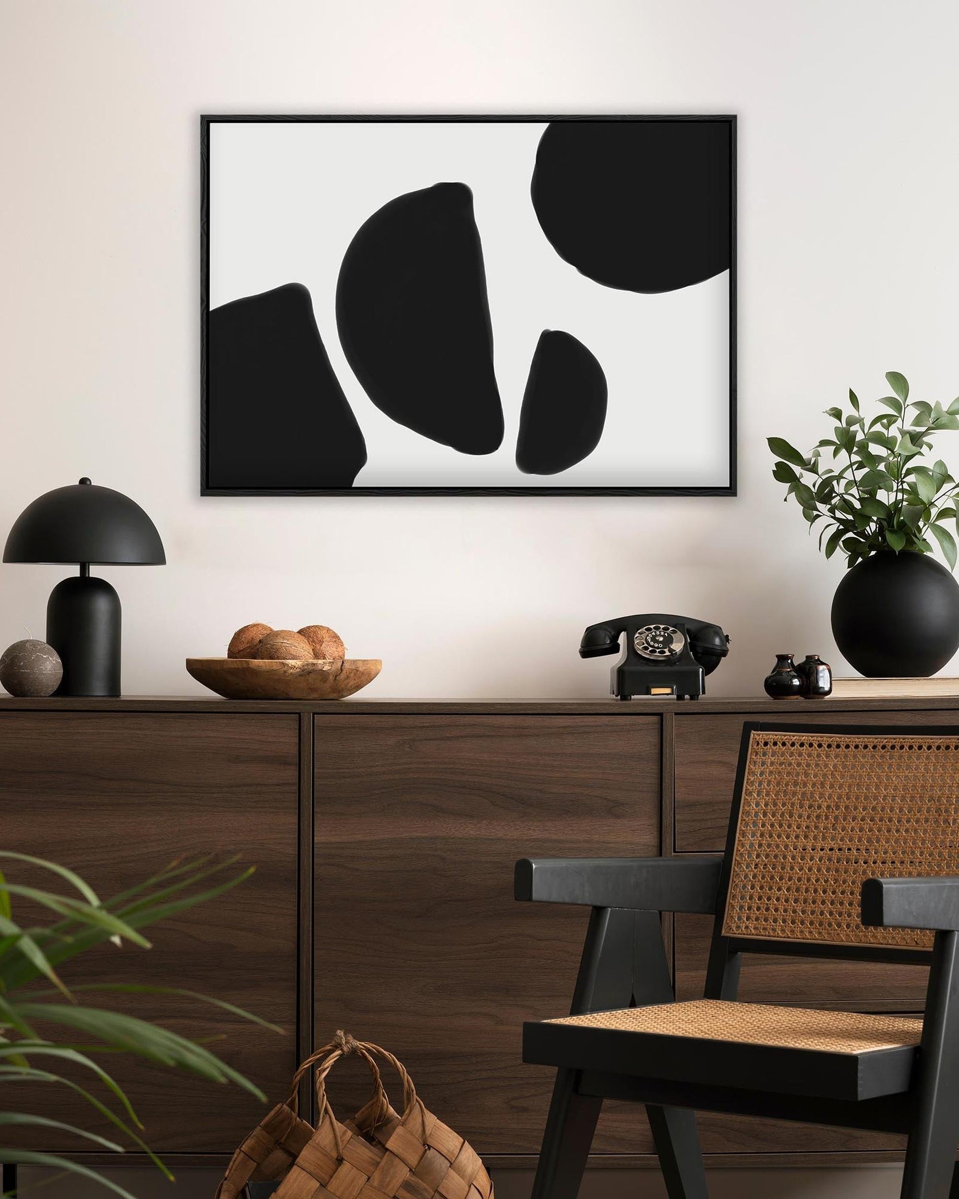 Modern interior with a wooden cabinet, abstract art, and decorative items.