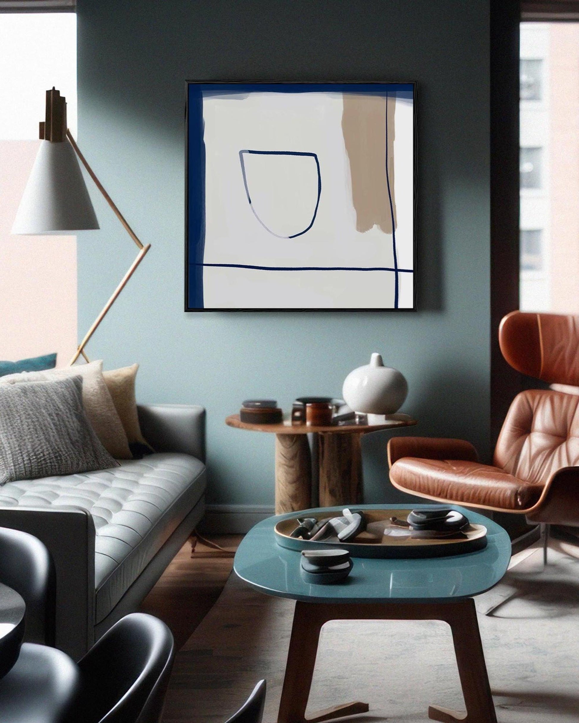 Modern living room with a gray sofa, brown armchair, and abstract art on the wall.