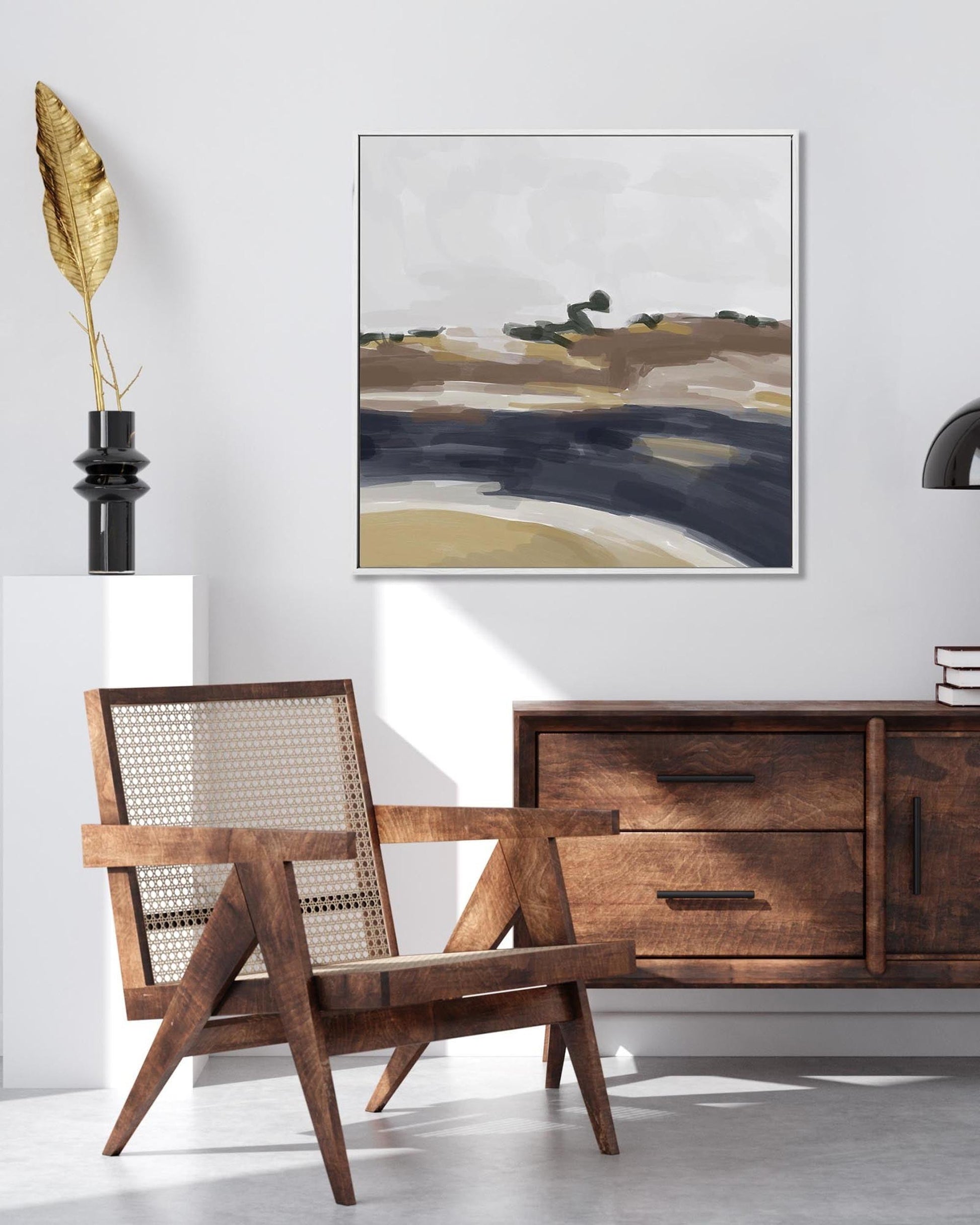 Wooden armchair and sideboard with abstract painting in a room setting