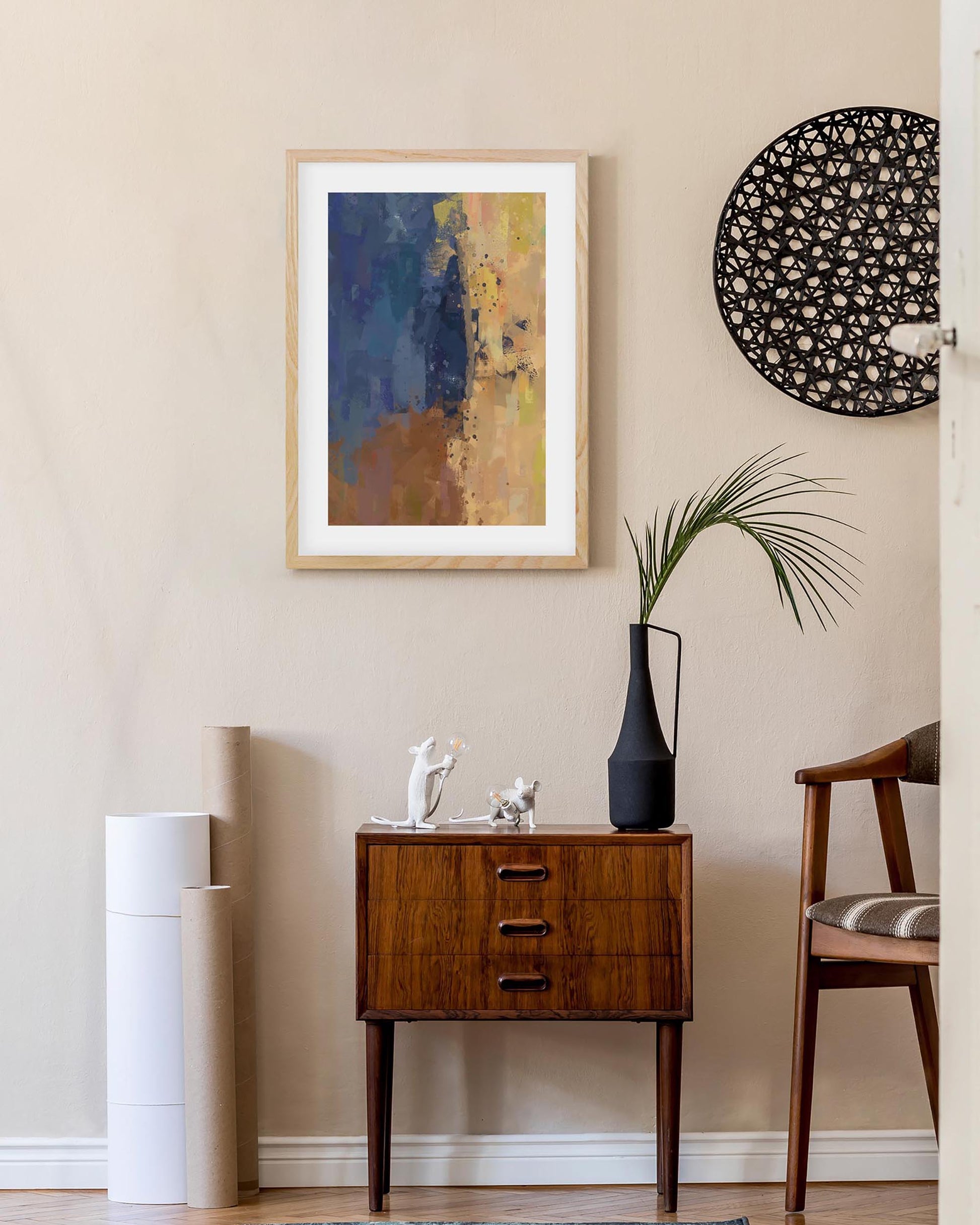 Modern interior with abstract art, side table, and chair against a beige wall.