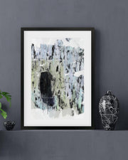 Framed abstract art print on a gray wall with decorative elements.