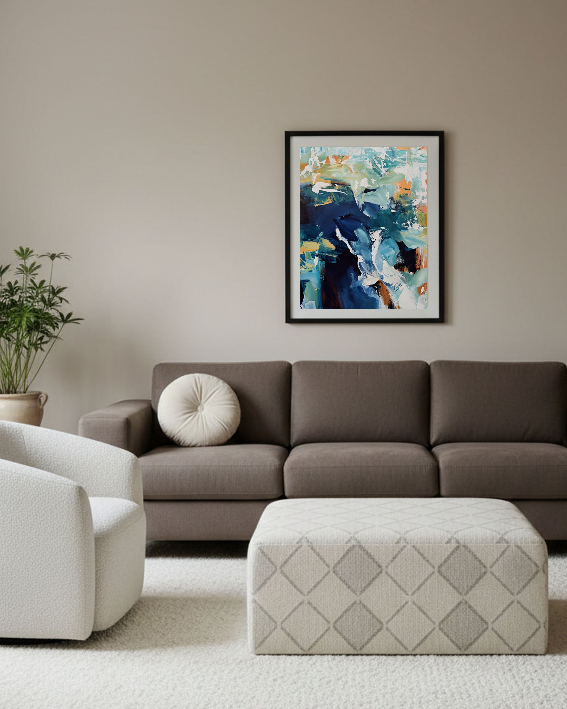 Living room with a brown sofa, white armchair, and abstract painting on the wall.