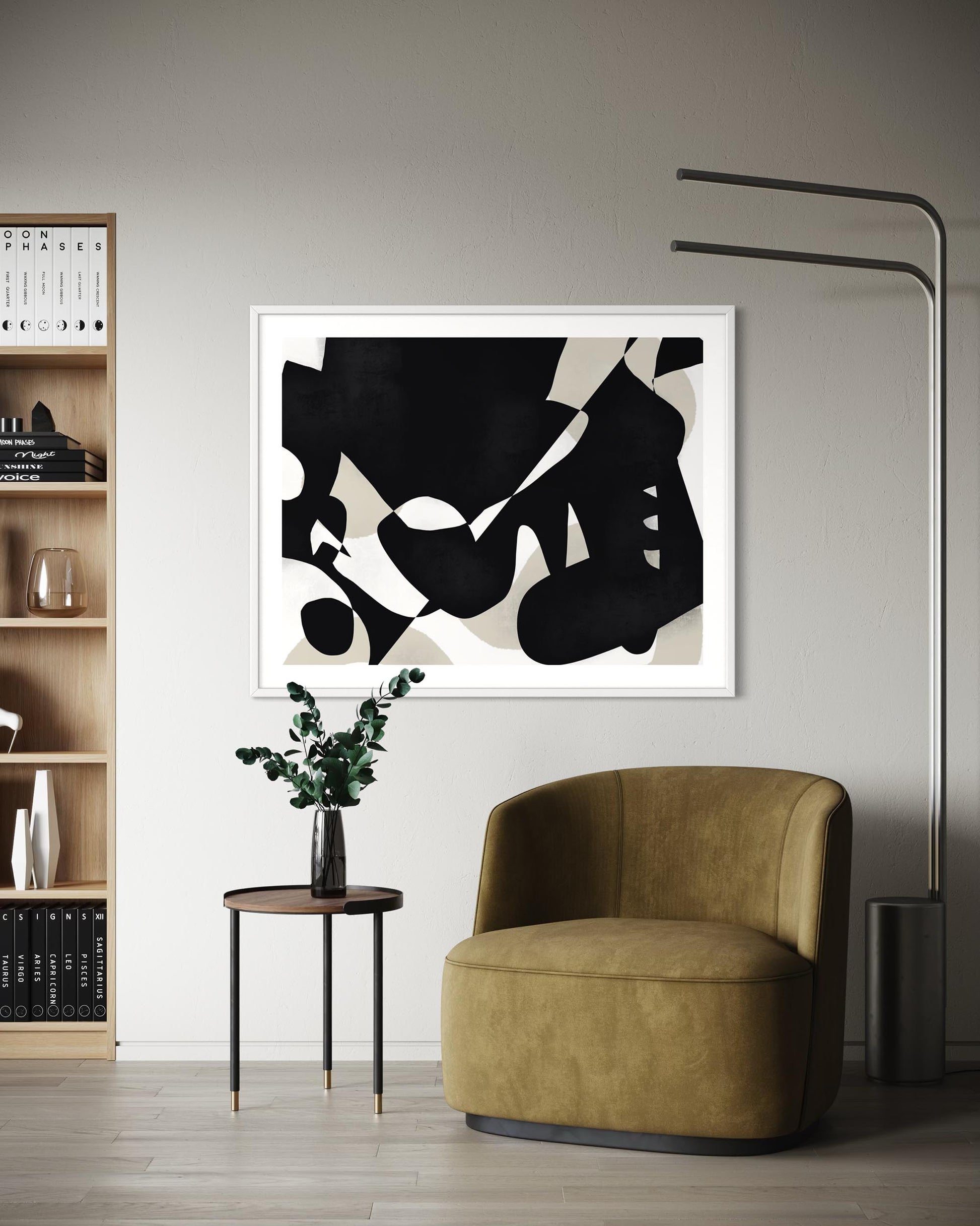 Modern interior with a brown armchair, abstract art, and bookshelf.