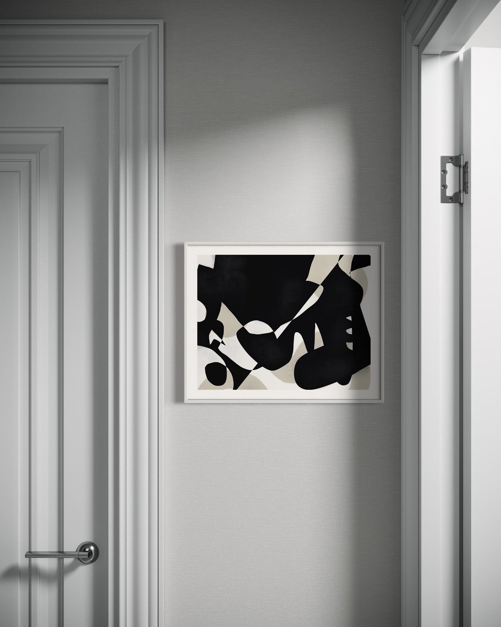 Abstract black and white artwork on a gray wall