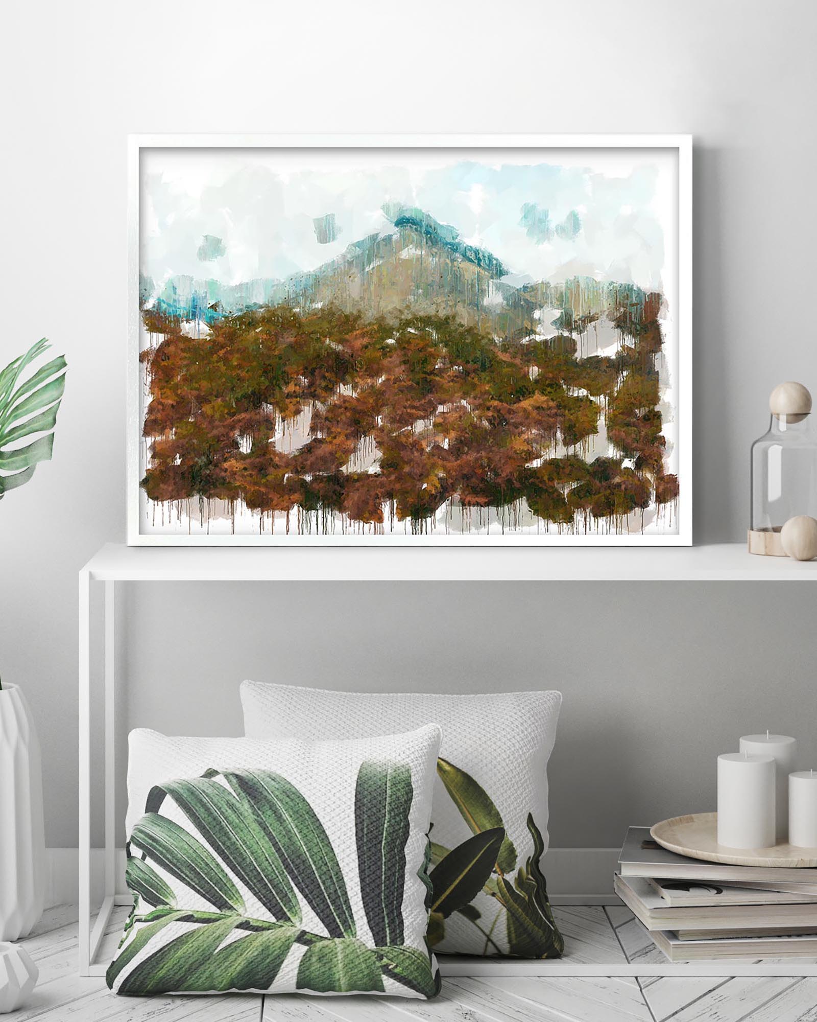 Framed abstract art piece on a wall above a white console table with decorative items.