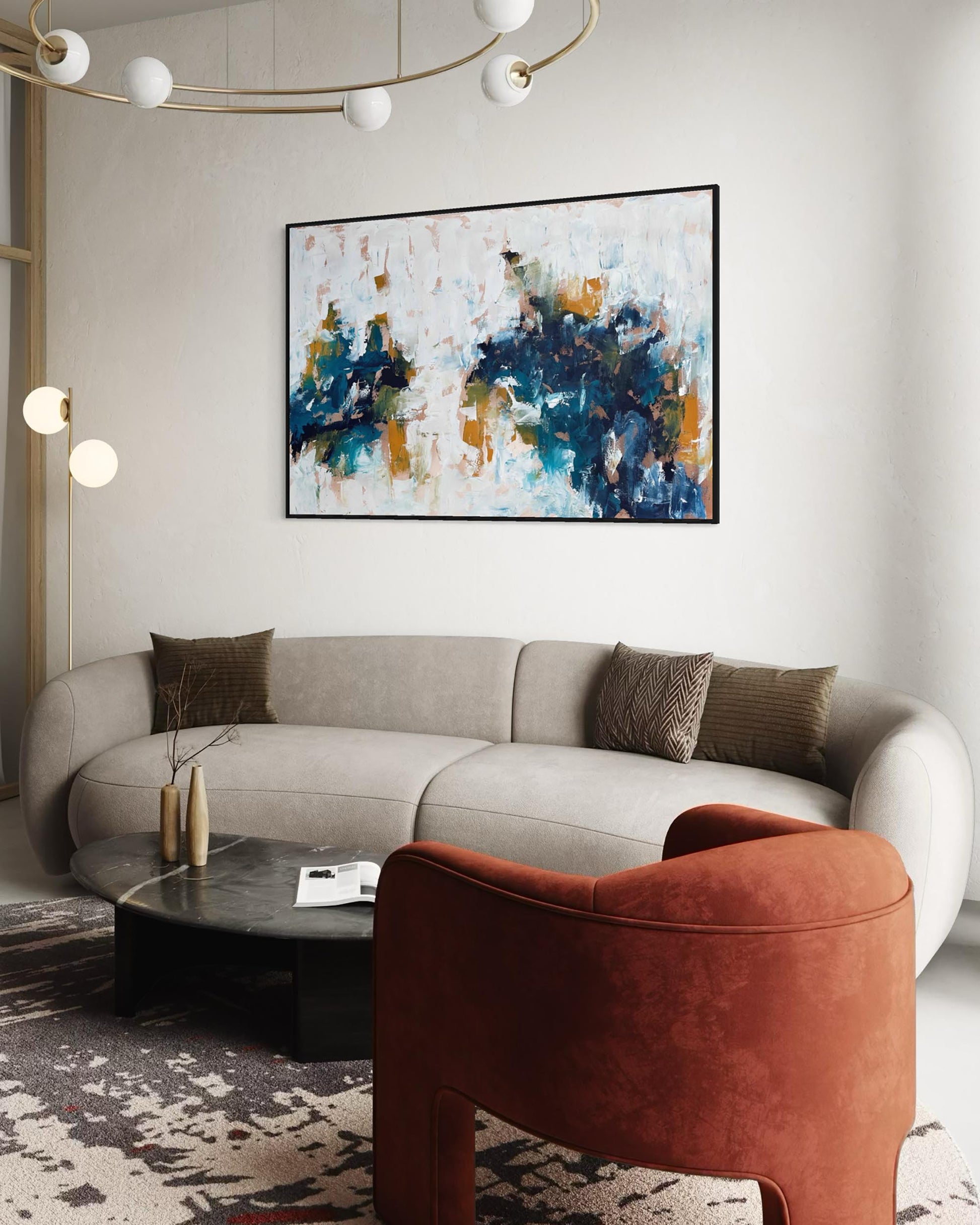 Modern living room with a gray sofa, brown armchair, and abstract painting on the wall.