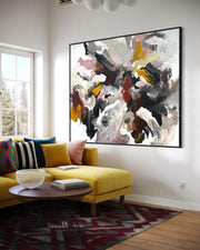 Living room with a yellow sofa, colorful pillows, and a large abstract painting on the wall.