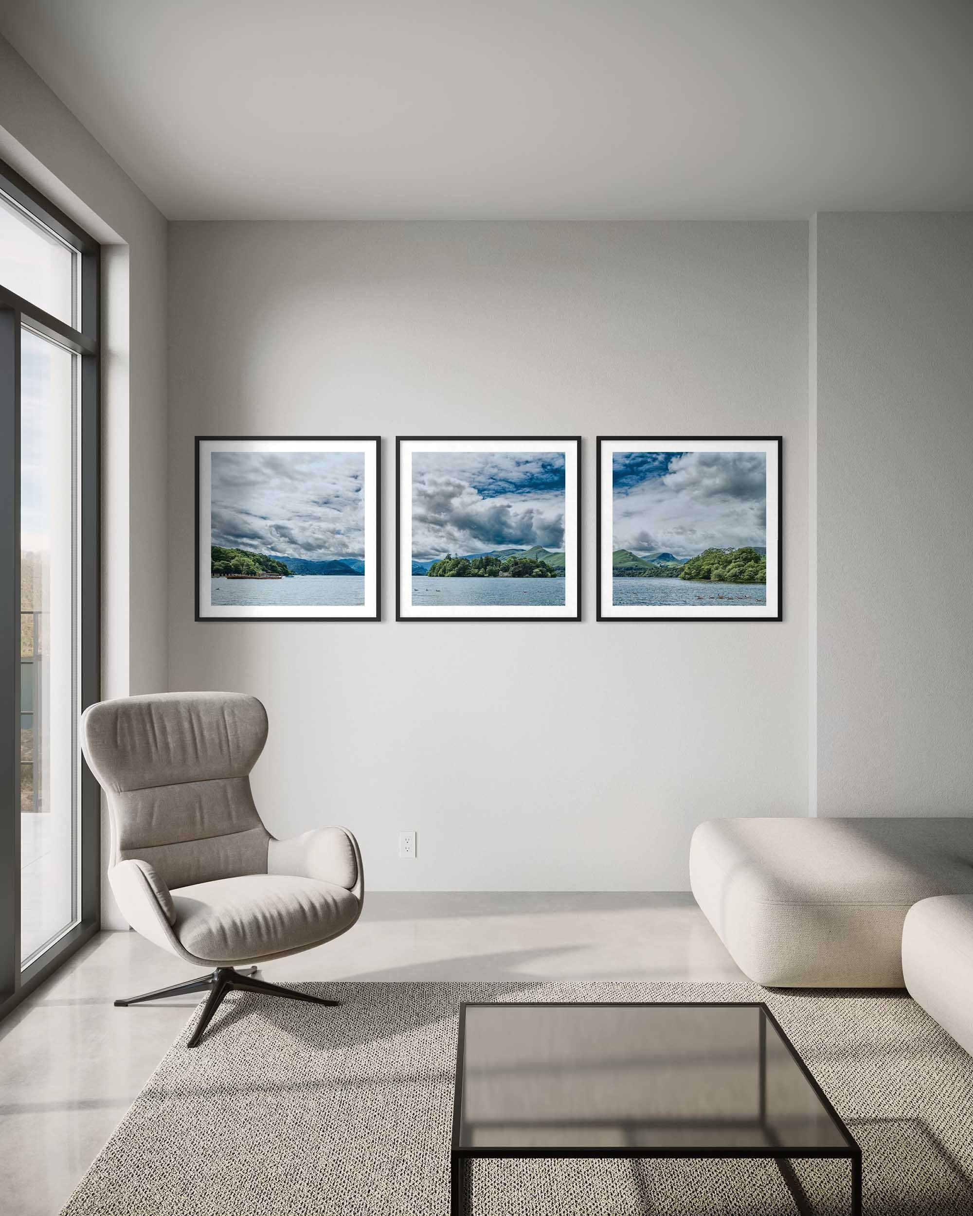 Modern living room with a gray armchair, glass coffee table, and three framed landscape pictures on the wall.