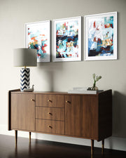 Wooden sideboard with abstract art on a wall