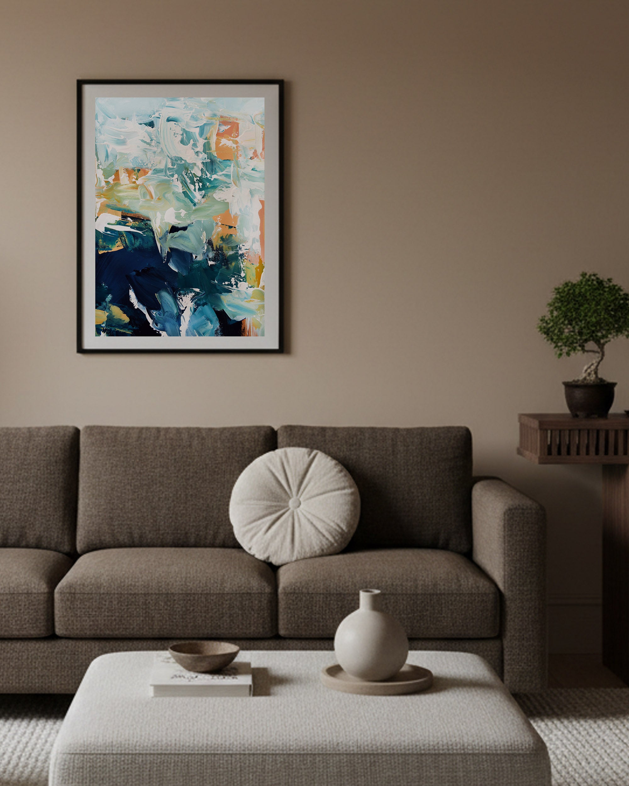 Living room with a brown sofa, abstract painting, and decorative items.