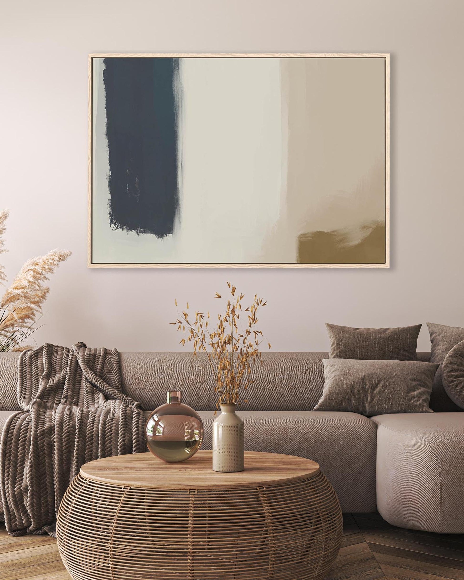 Modern living room with a gray sofa, abstract art, and decorative items.