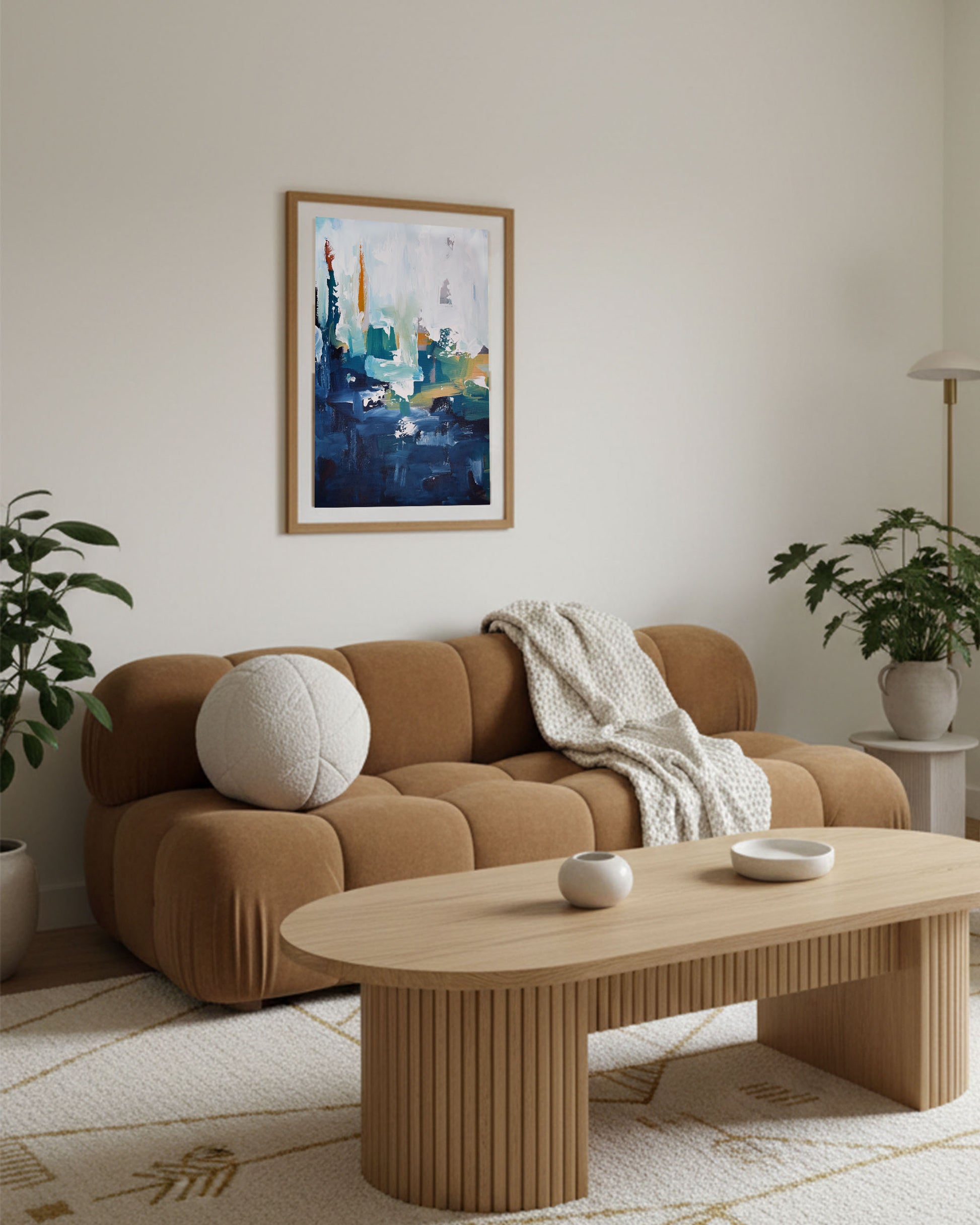 Modern Japandi bohemian living room interior with brown bubble sofa, comfortable living interiors, with large navy and teal abstract wall art framed in oak, with scandinavian coffee table