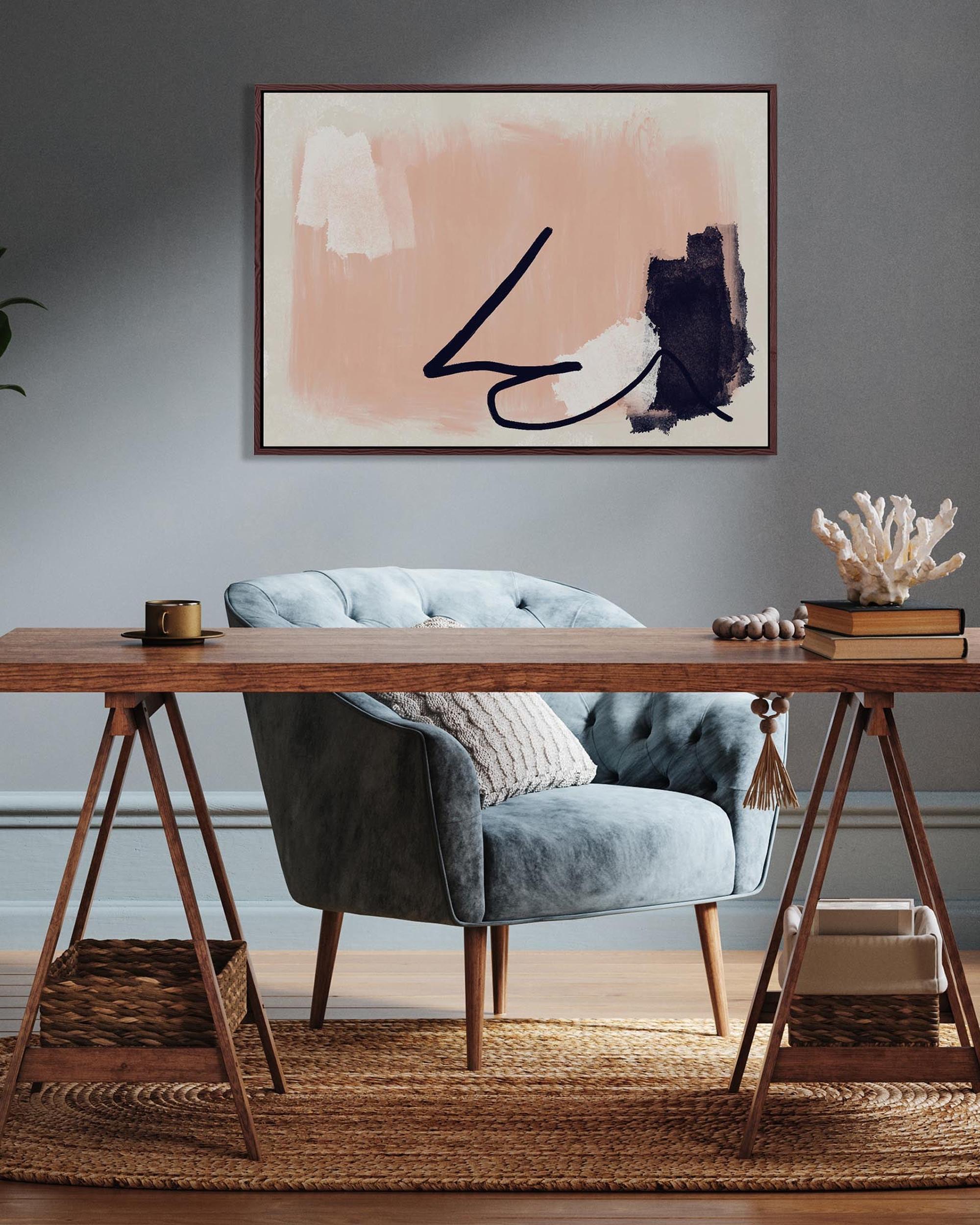 Modern interior with a wooden desk, gray armchair, and abstract art on the wall.