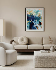 Modern living room with a beige sofa, armchair, and abstract painting on the wall.