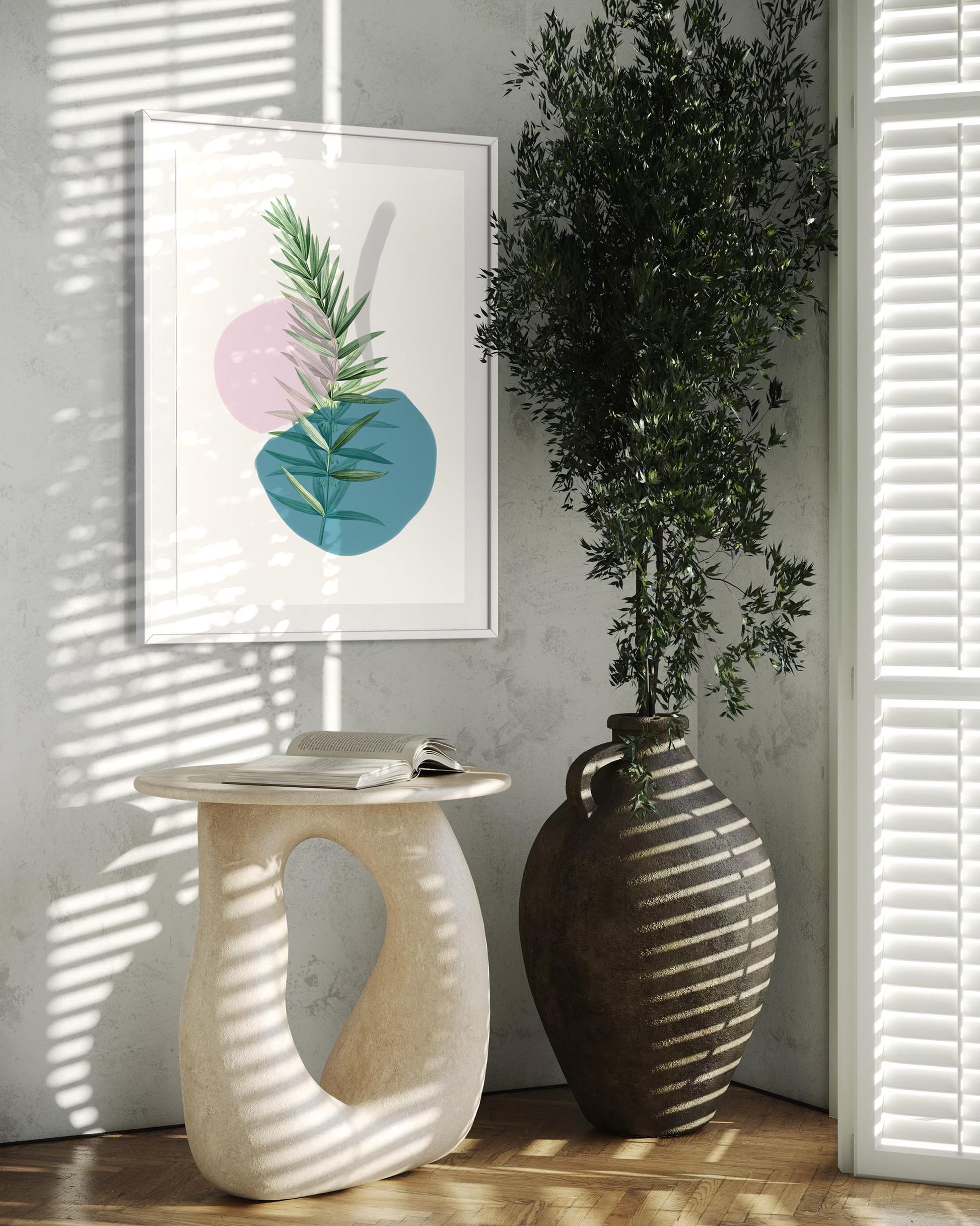 Decorative plant in a vase next to a framed artwork with abstract leaves on a wall.