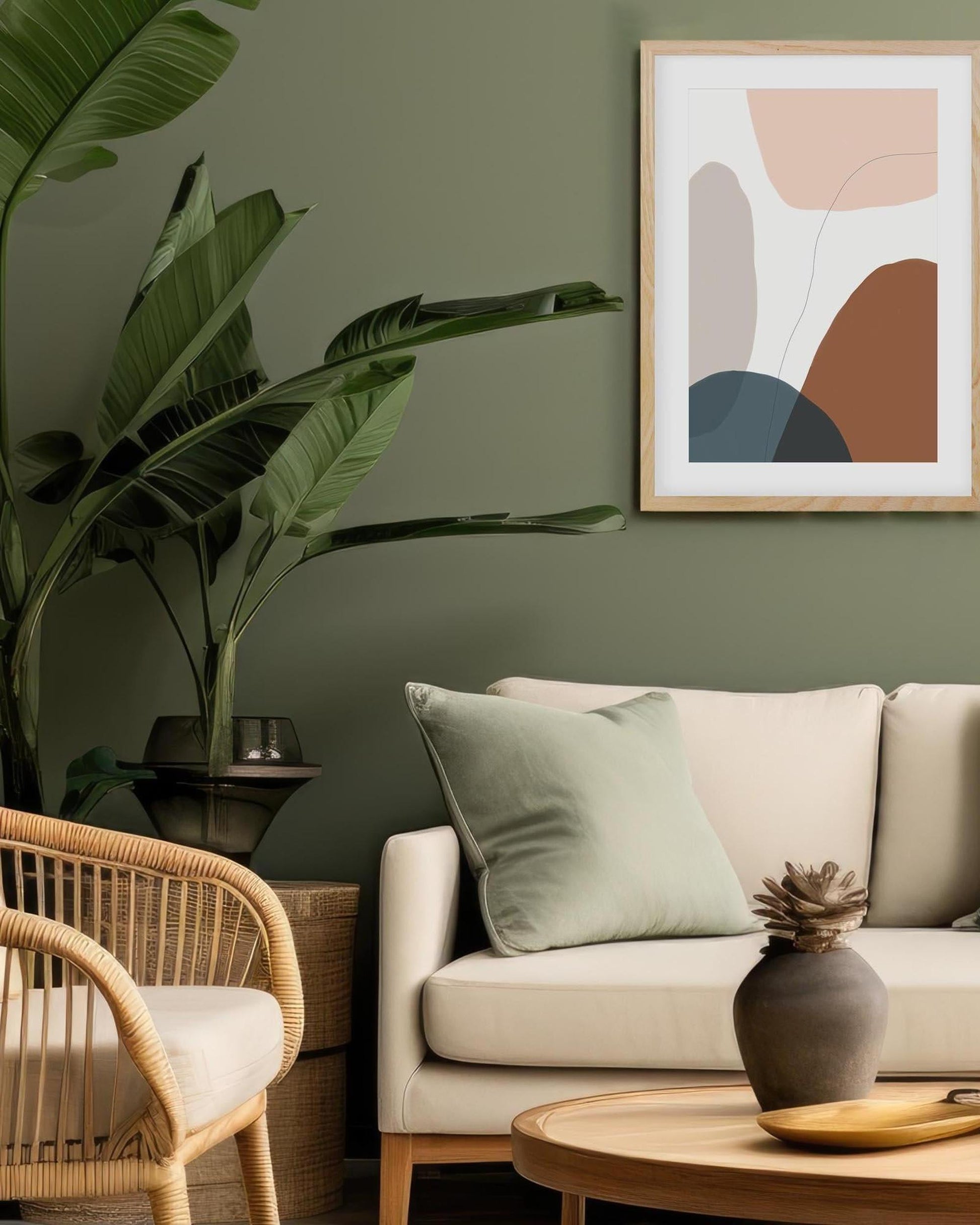 Living room with a beige sofa, wicker chair, and abstract art on a green wall.