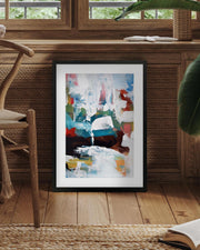 Framed abstract painting in a room with wooden furniture and plants