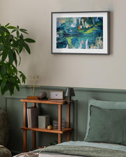 Framed abstract painting on a wall above a wooden shelf in a room with green walls and a plant.