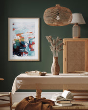 abstract art print in oak frame in a modern dining room