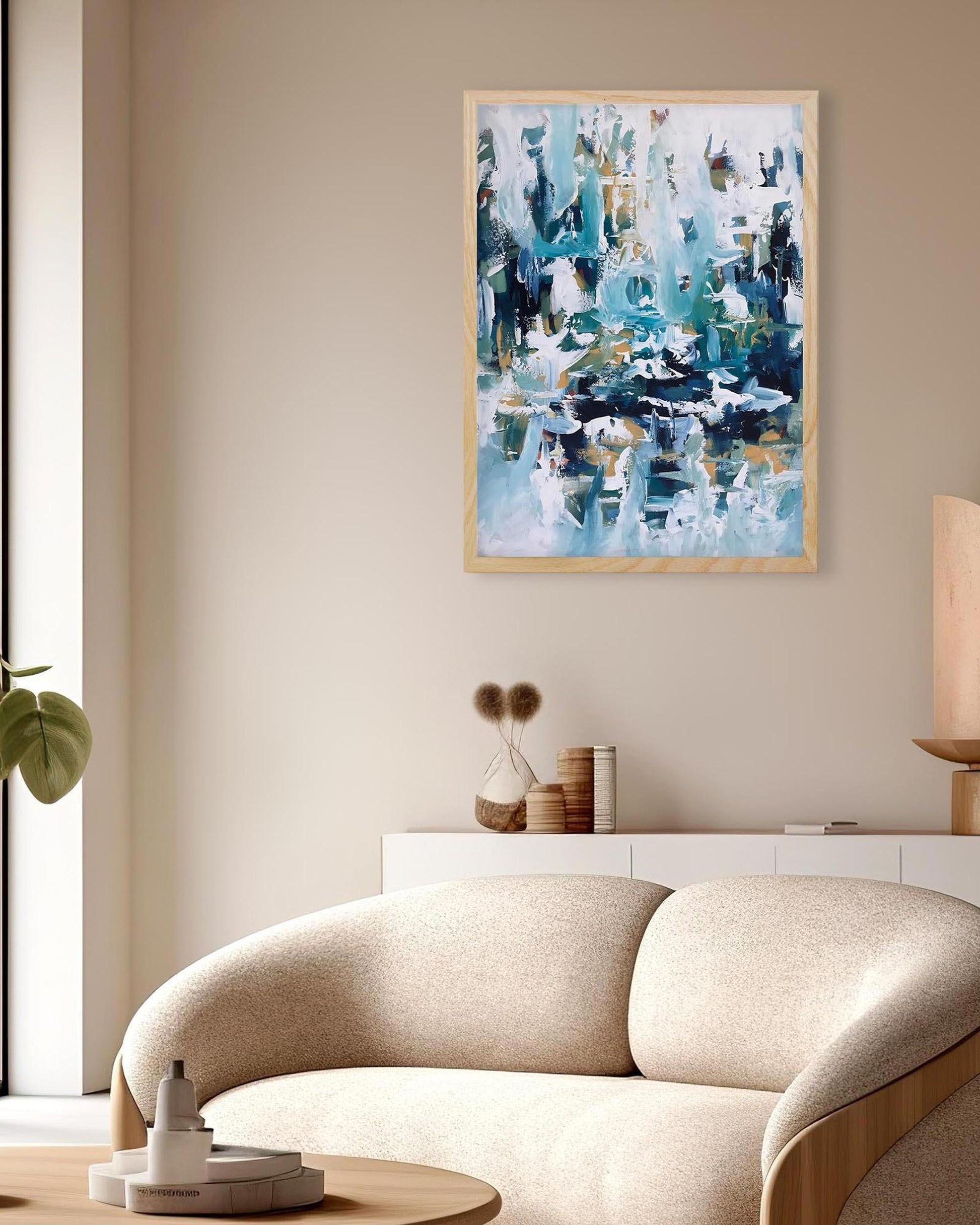 Abstract art piece on a wall above a modern sofa in a living room setting.