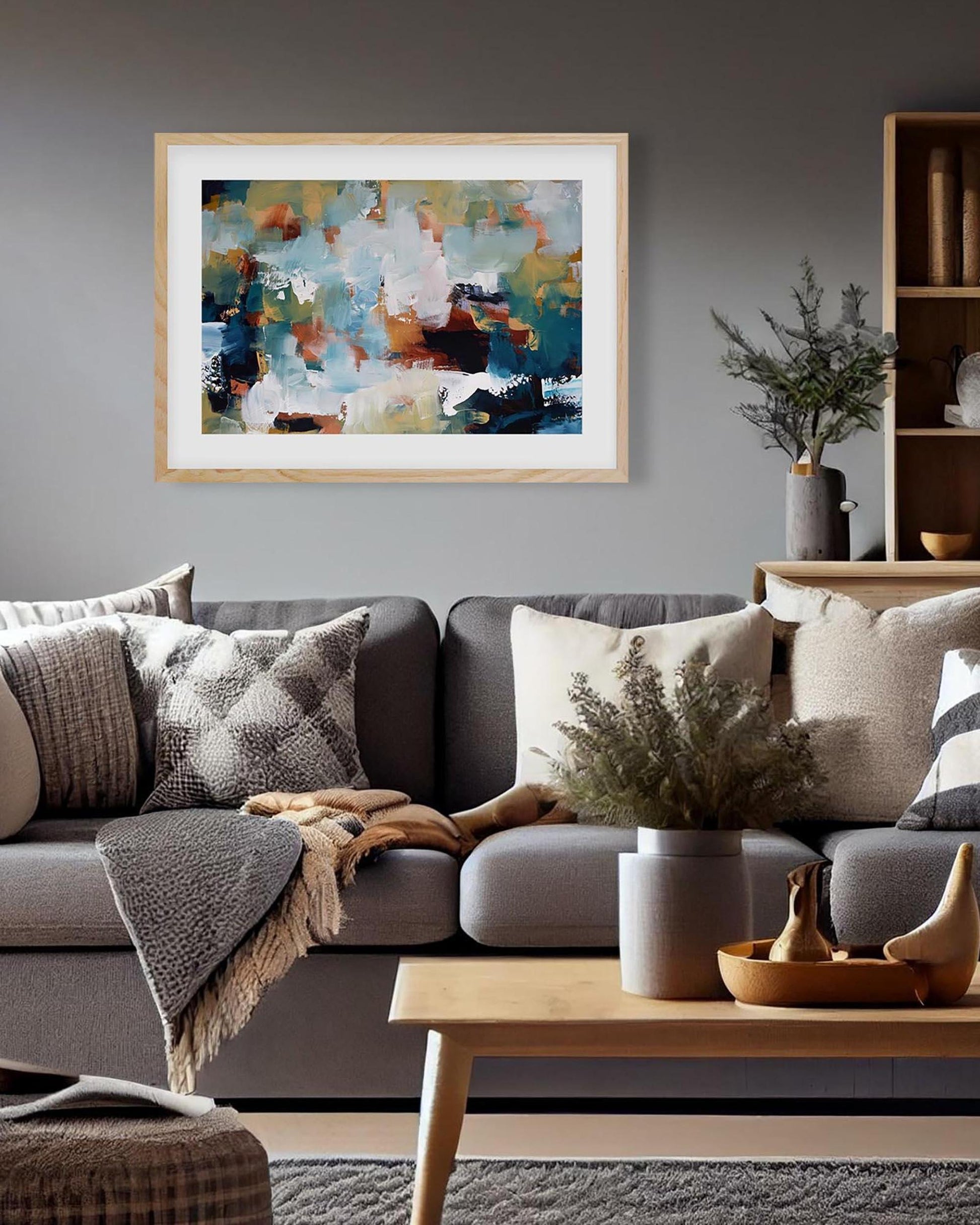 Living room with a gray sofa, coffee table, and abstract painting on the wall.