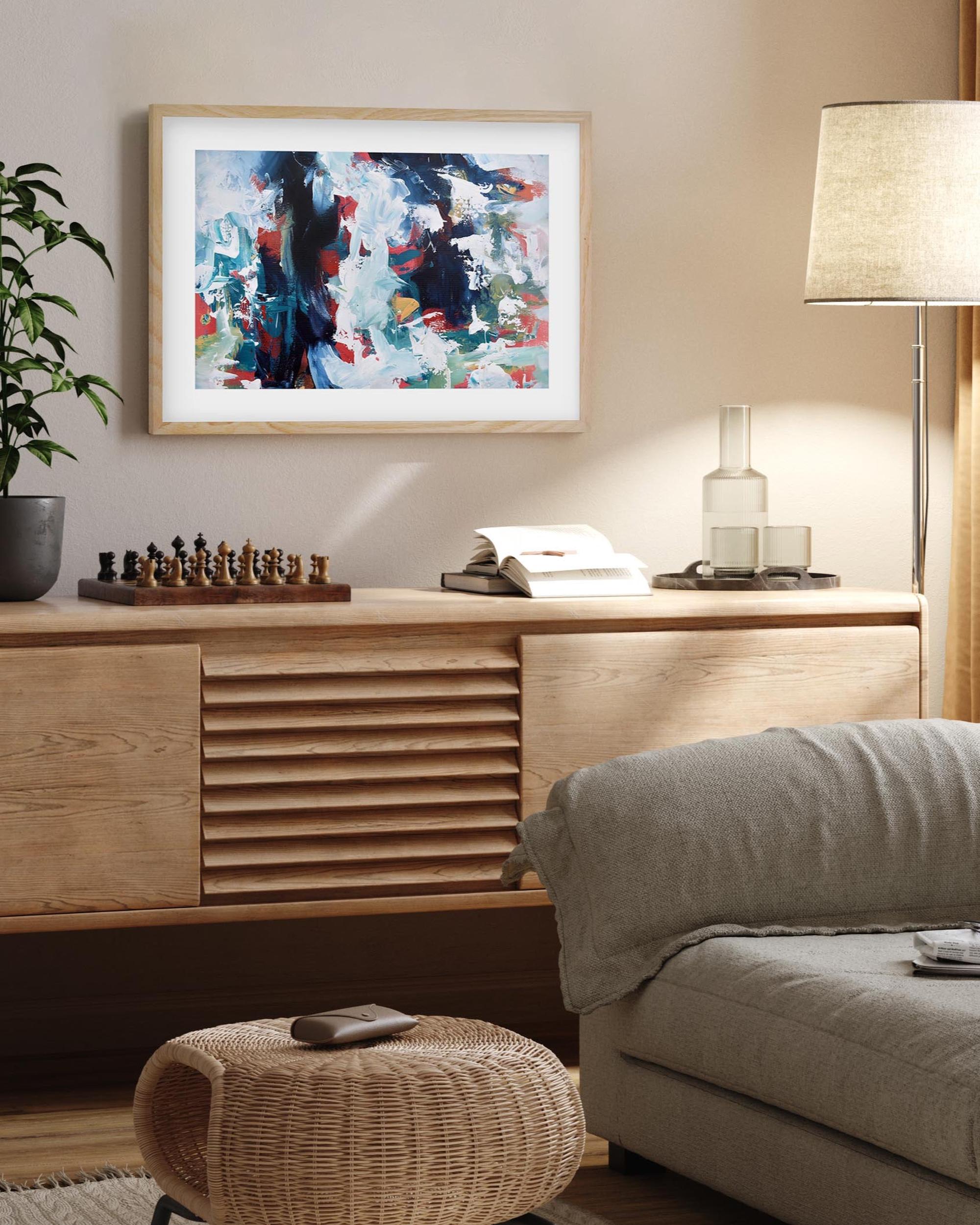 Living room with wooden sideboard, abstract art, and decor items.