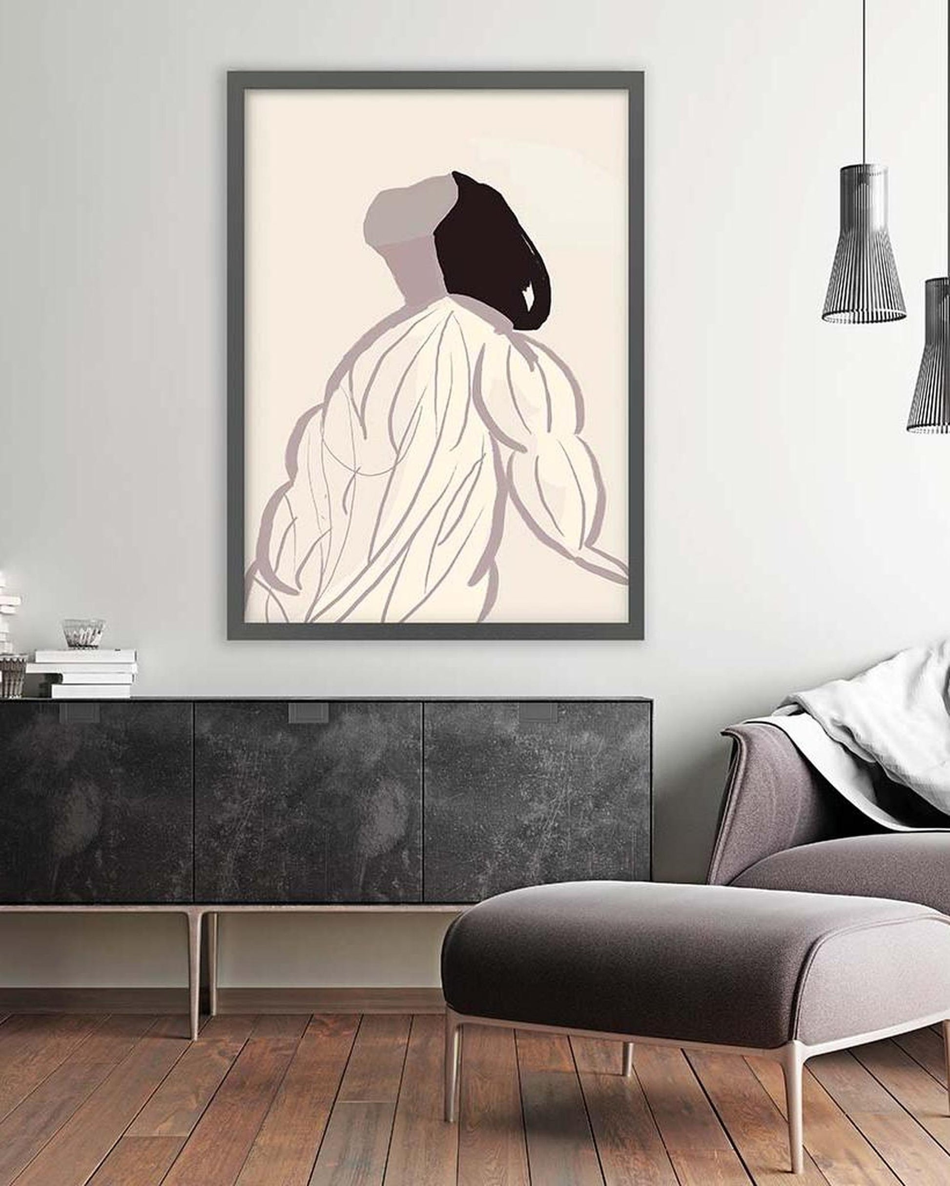 Framed abstract art piece on a wall in a modern living room.