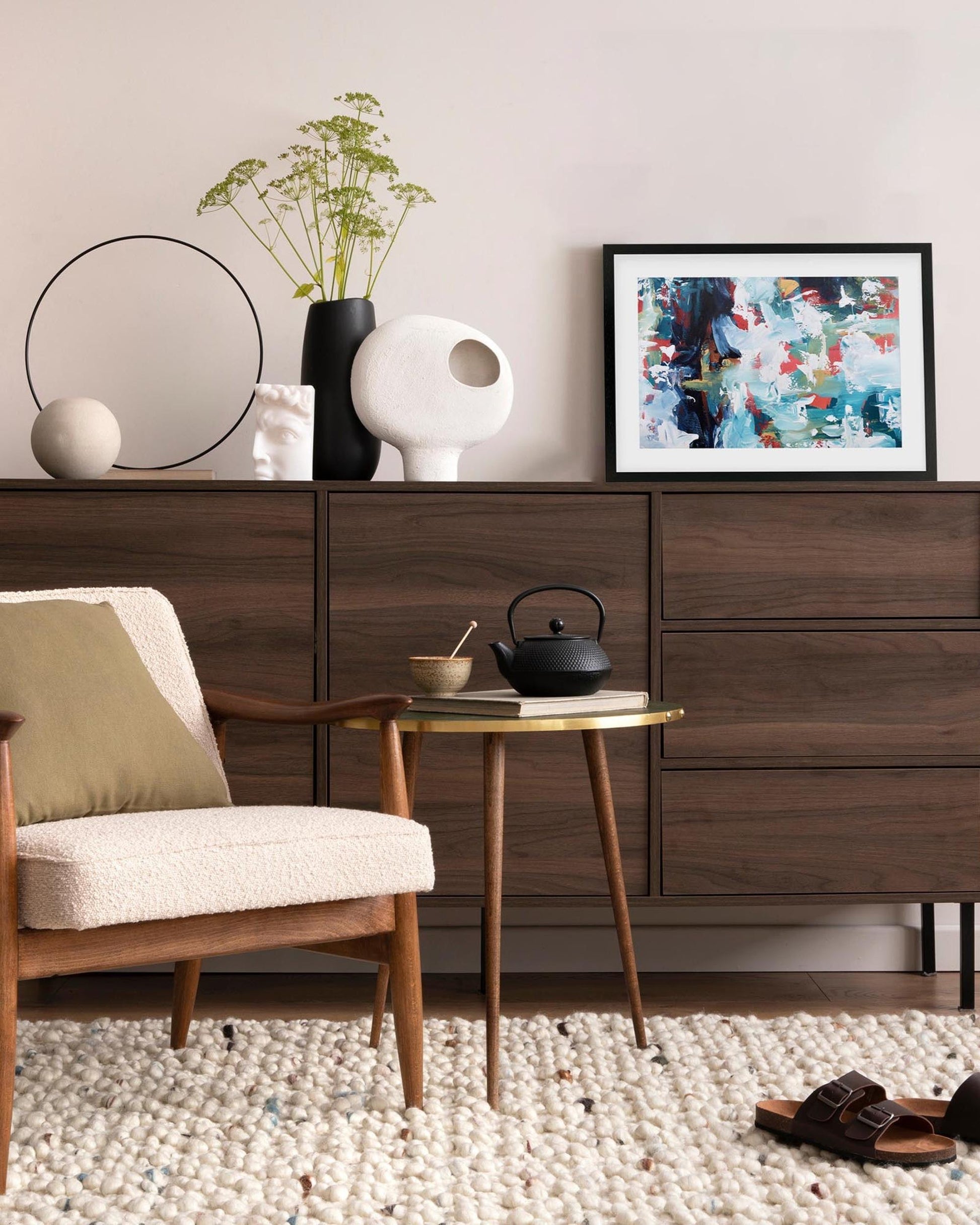 Modern living room with wooden furniture, decorative items, and a chair.