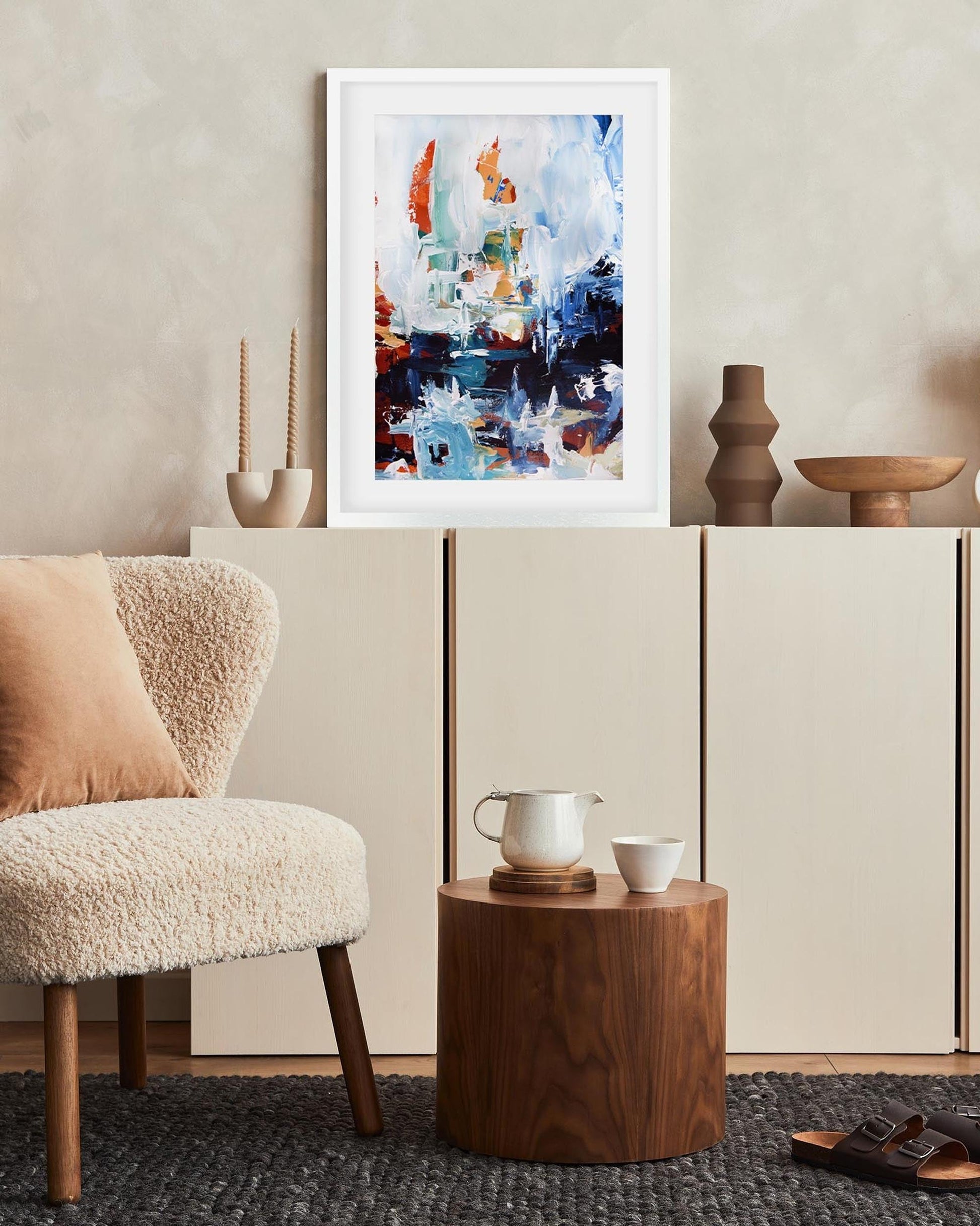 Modern living room with abstract art, chair, and side table.