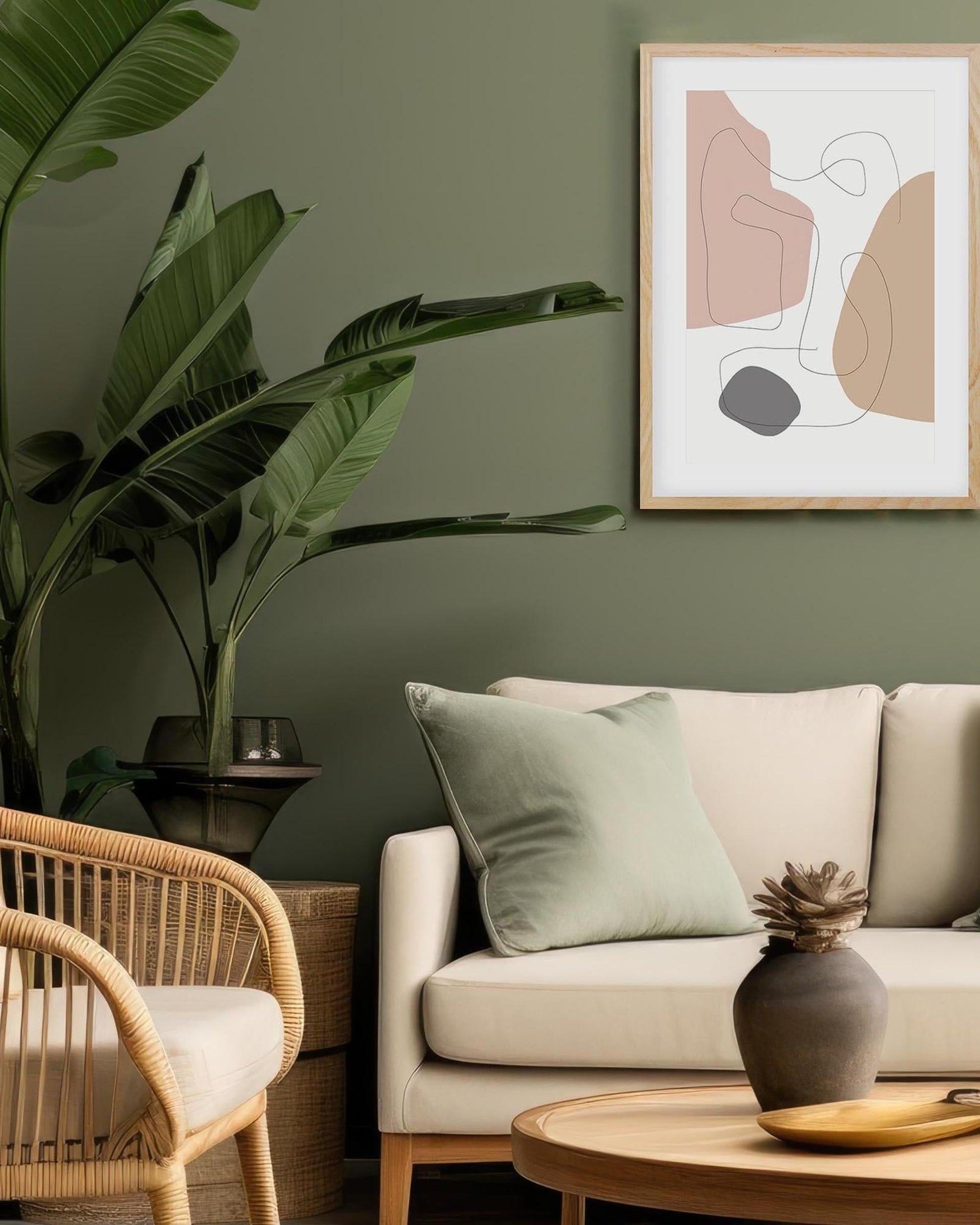 Living room with beige sofa, wicker chair, and abstract art on a green wall