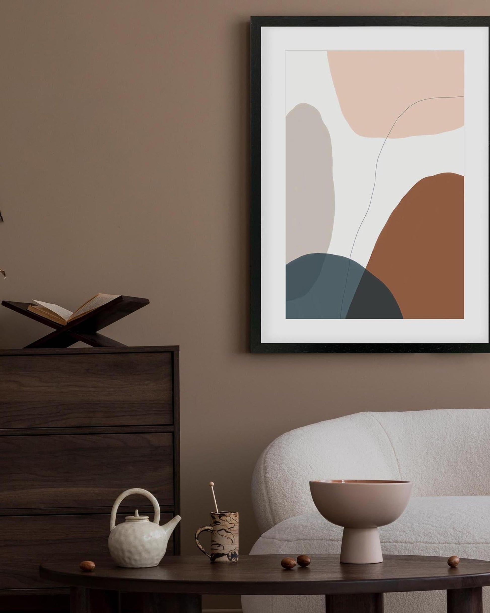 Abstract art print on a wall in a living room with furniture and decor.