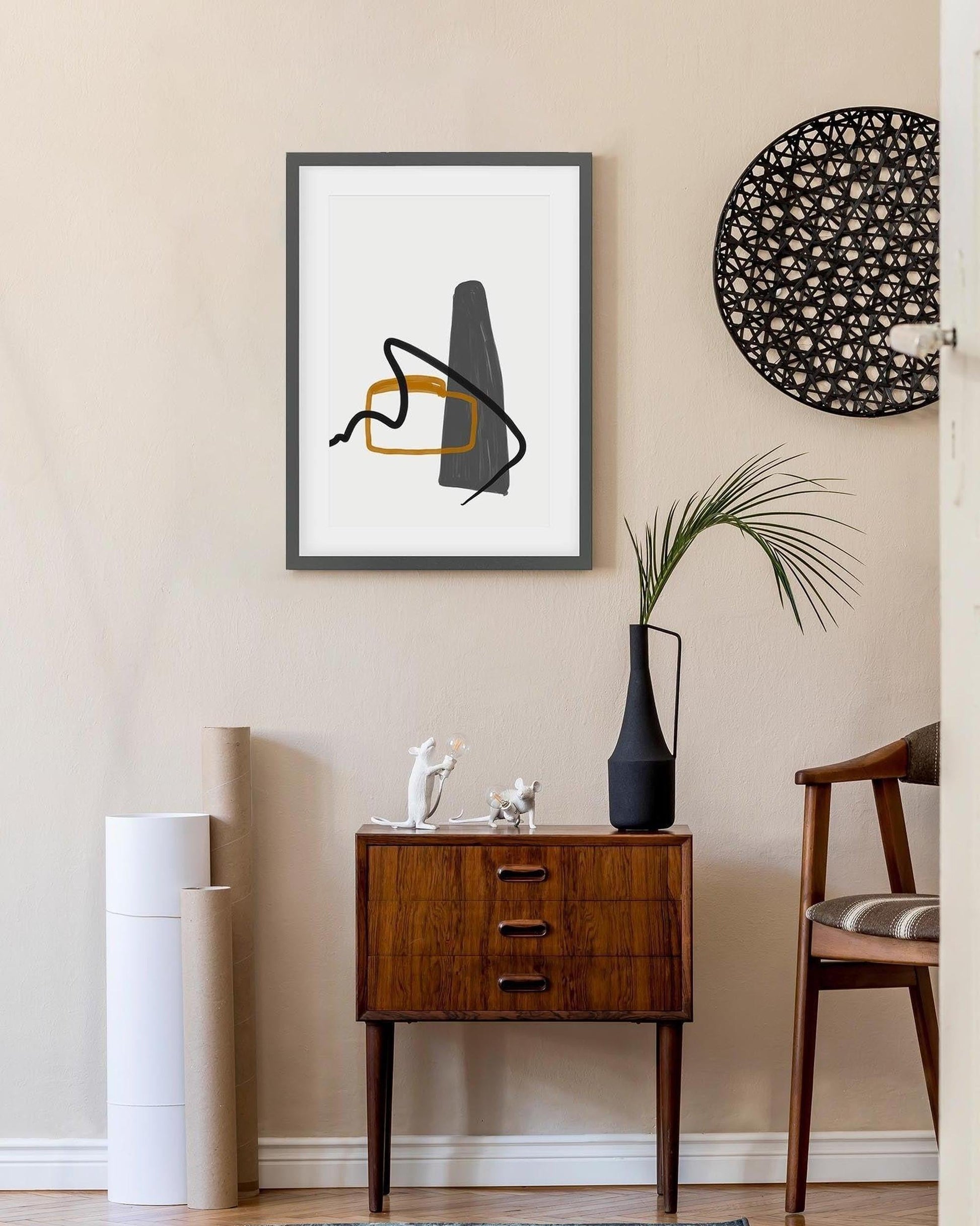 Modern interior with abstract art, side table, and decorative items.