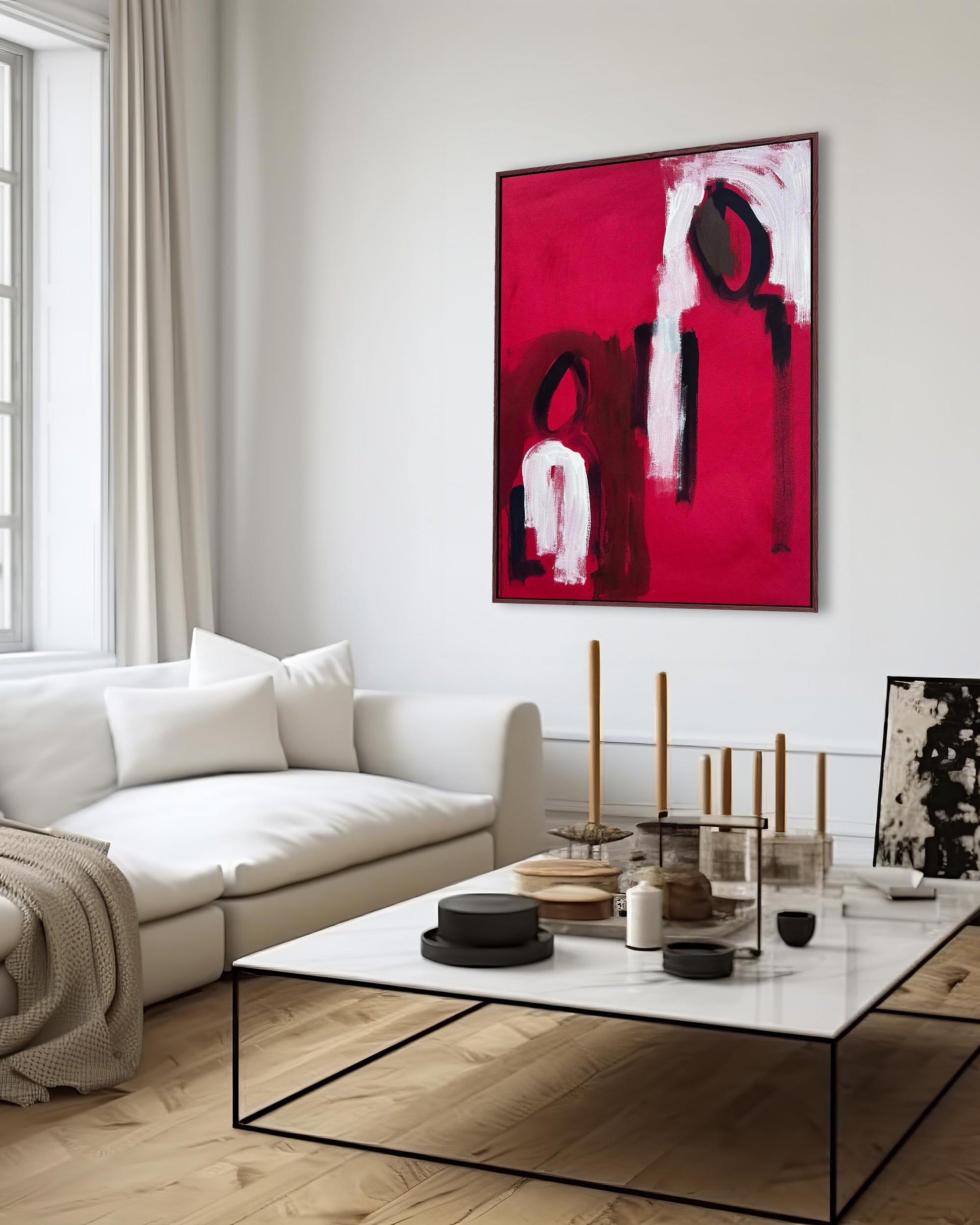 Modern red magenta pink large oversized abstract painting on living room wall above marble coffee table and white sofa.