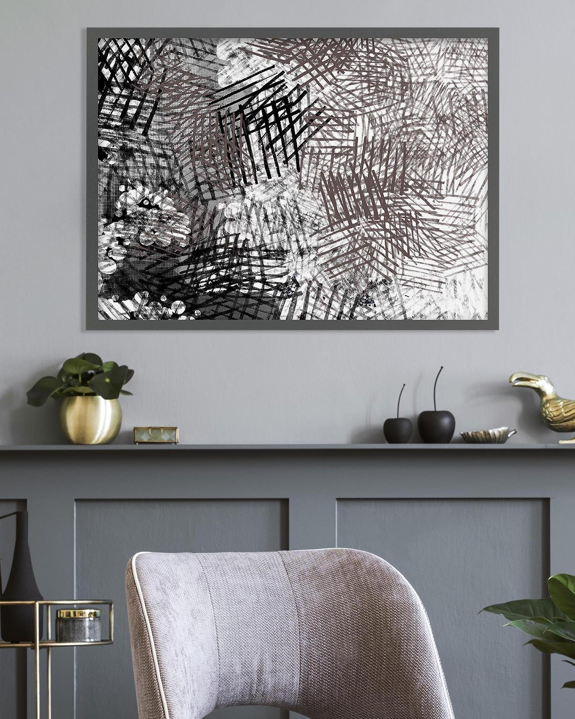 Abstract art piece on a wall above a shelf with decorative items.