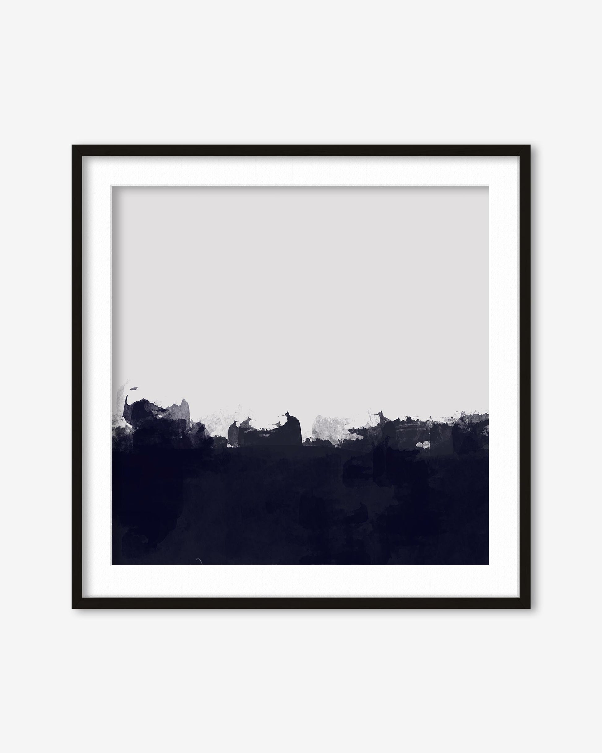 Framed black and white abstract art print on a white wall