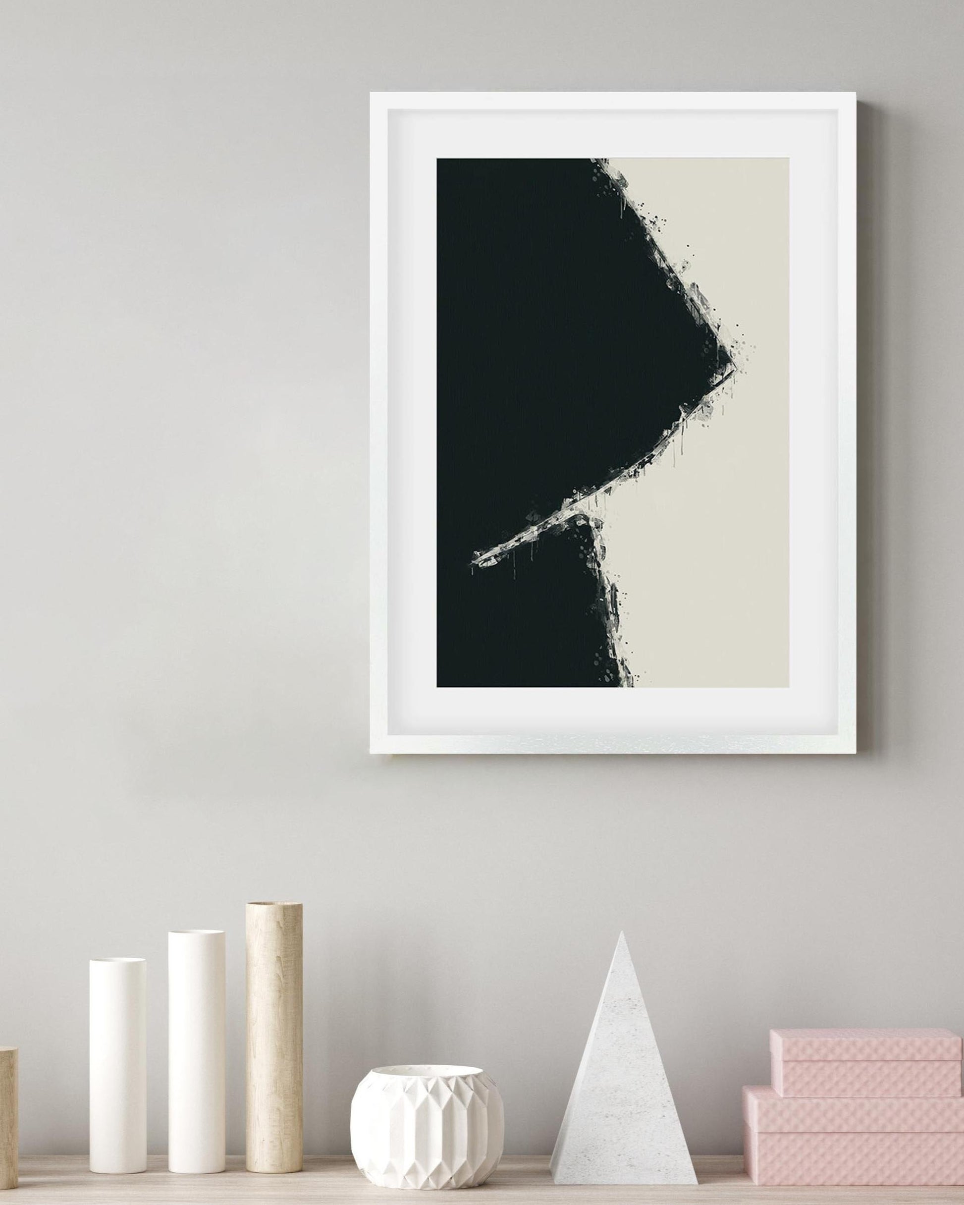 Framed abstract art print on a wall with decorative items below