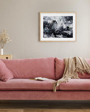 Pink sofa in a living room with abstract art on the wall