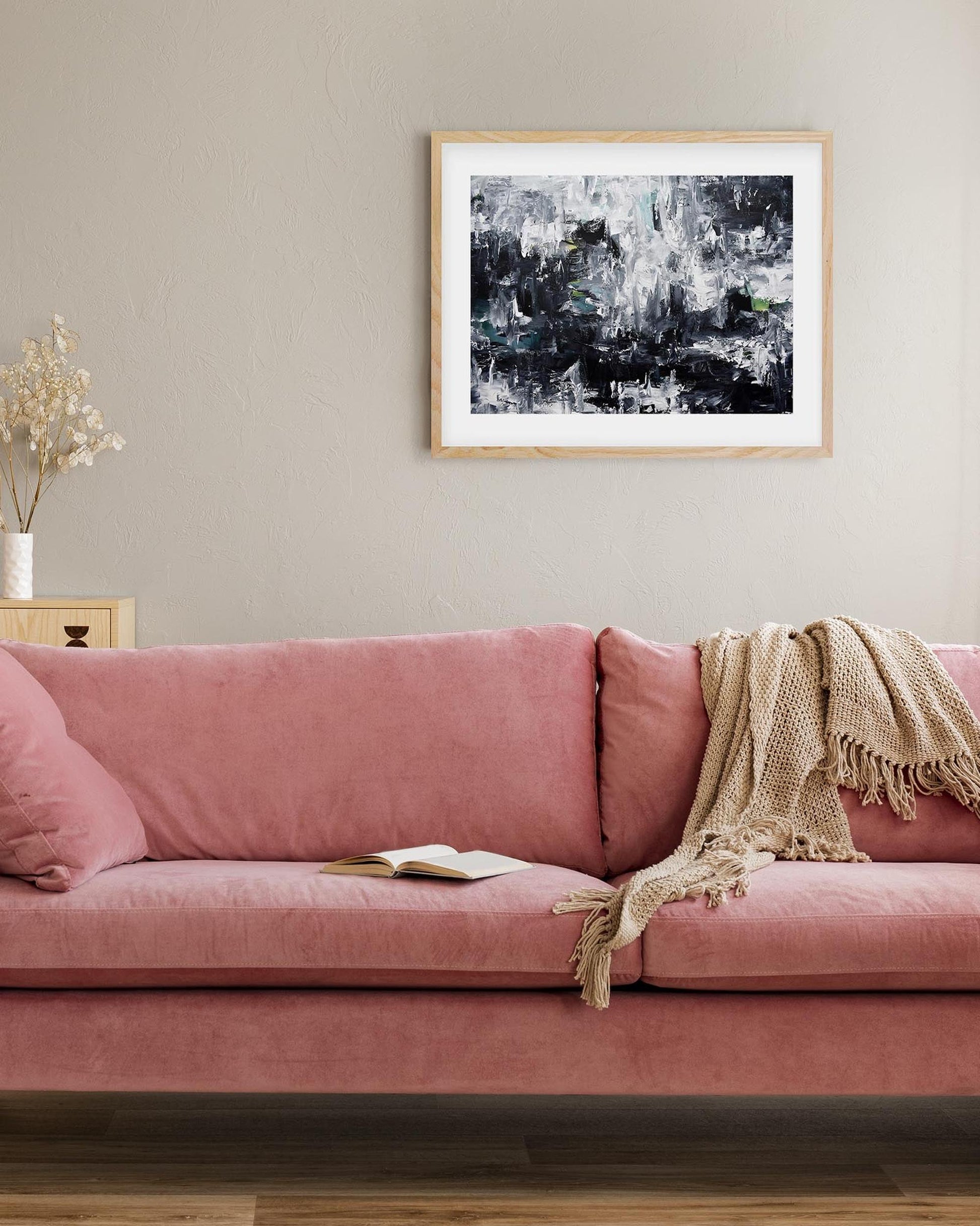 Pink sofa in a living room with abstract art on the wall