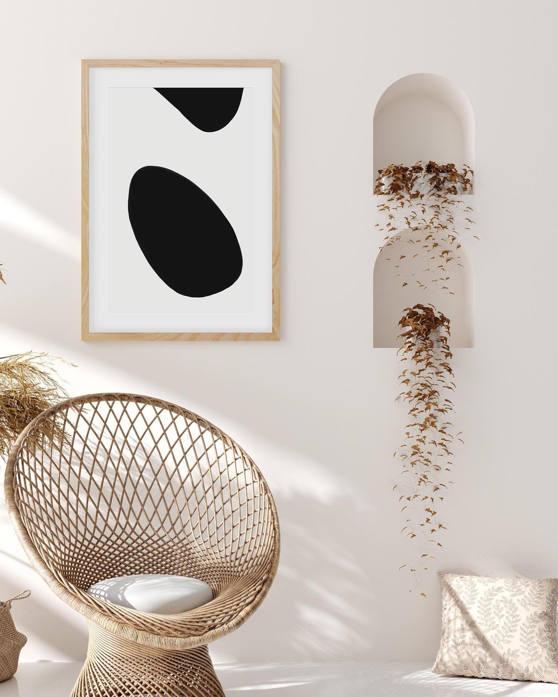 Modern interior with abstract art, wicker chair, and decorative pillow.