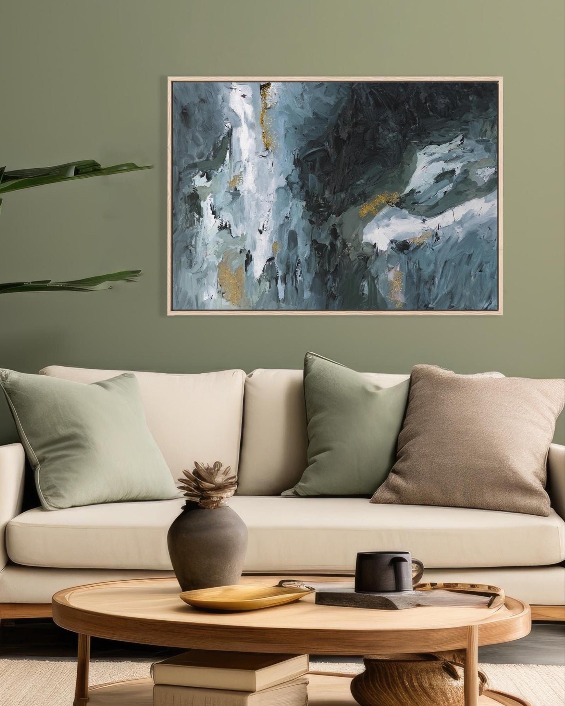 Living room with a beige sofa, abstract painting on the wall, and a wooden coffee table.