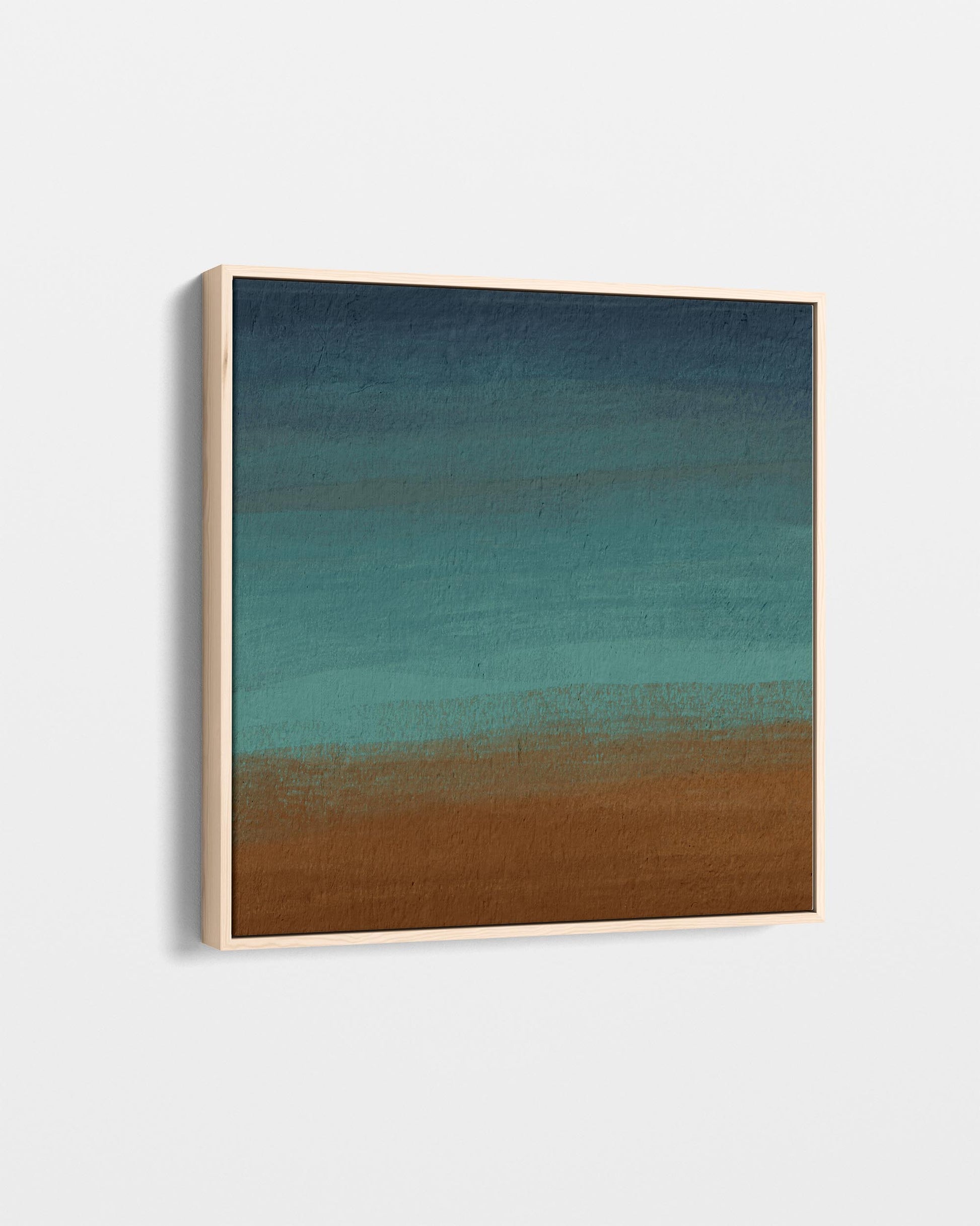 Abstract art piece with gradient from blue to brown in a wooden frame.